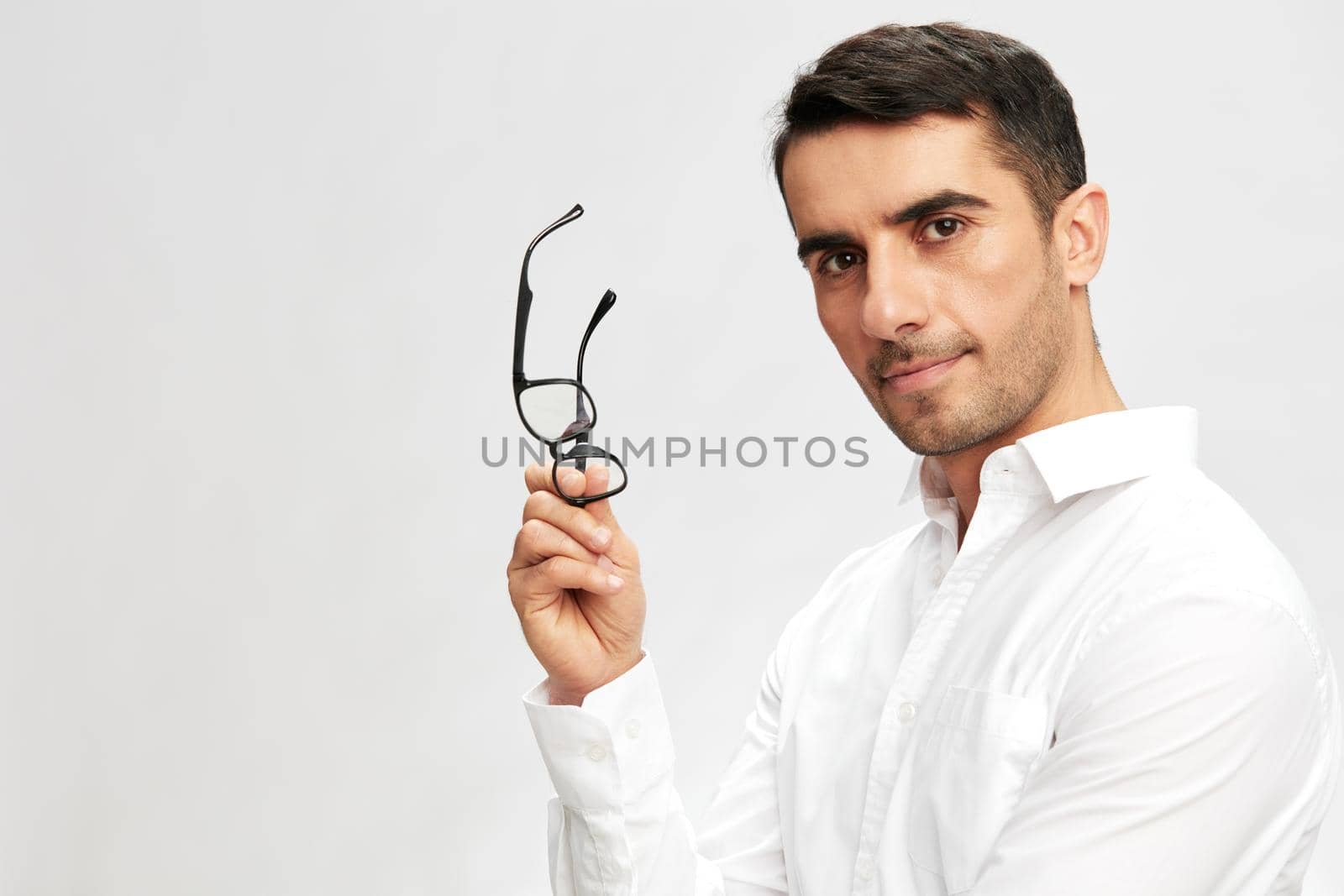 successful man holding glasses in hand in white shirts hand gesture copy-space isolated background by SHOTPRIME