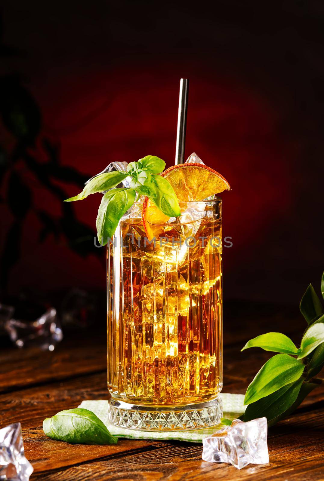 Glass of long island ice tea cocktail decorated with mint. Cuba Libre low key by PhotoTime