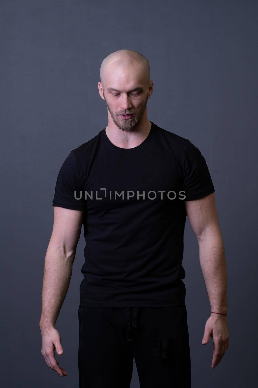 A guy standing in a black T-shirt is a beautiful sexy athlete handsome black man design blank, for healthy chest in lifestyle for athletic strong, isolated sporty. Abs fashion biceps, bodybuilder adult