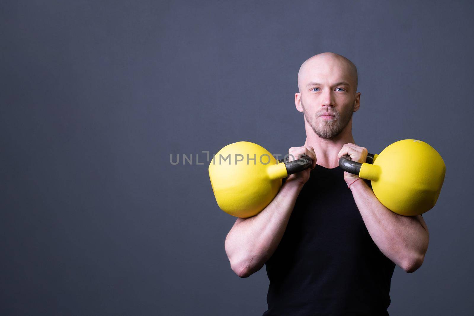 Guy with a yellow kettlebell gym anonymous yellow man, in the afternoon sporty effort from painted from floor youth, malaysian fitness. Guy down health, building hiit