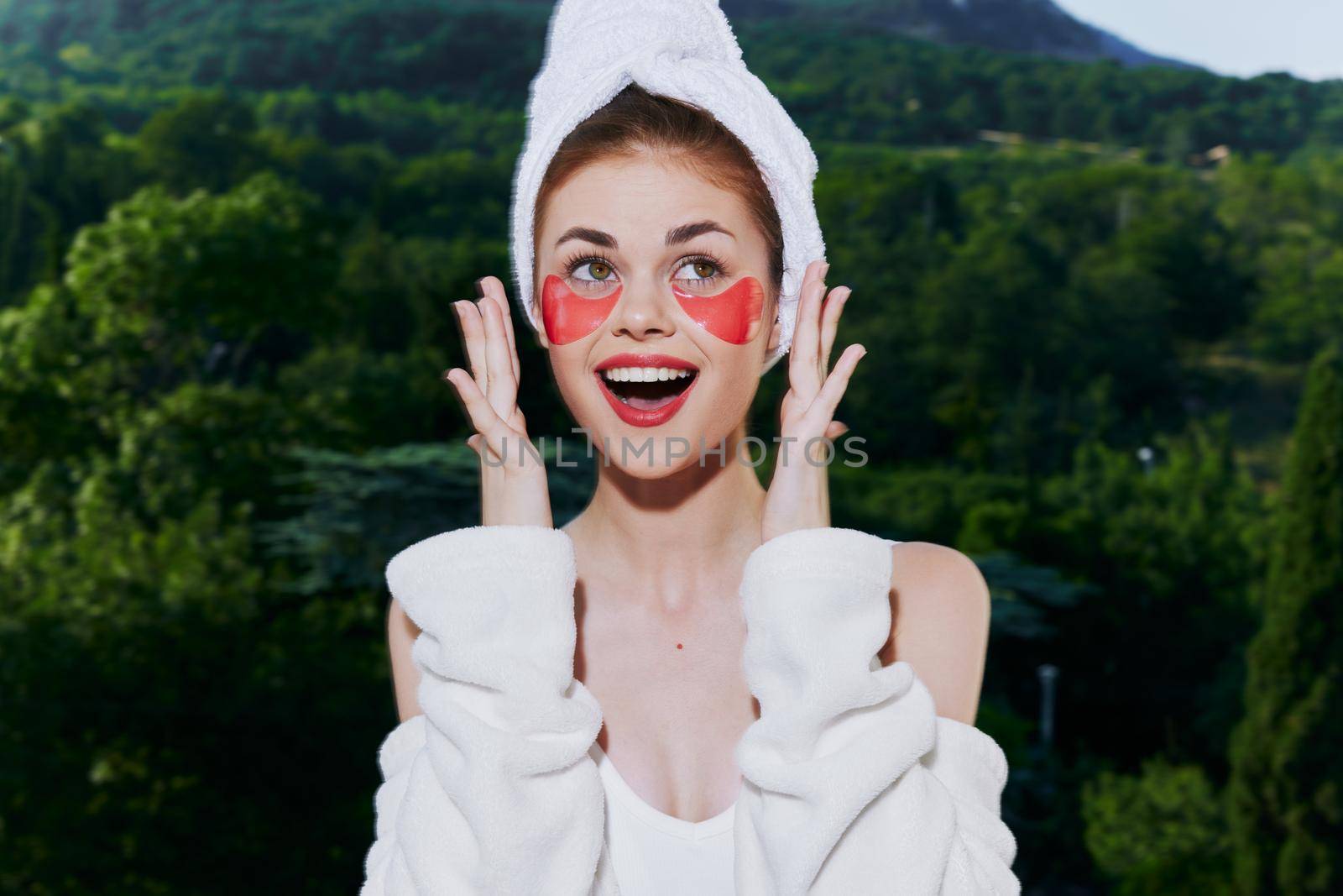 Portrait woman stands in a robe against the backdrop of mountains with patches on his face close-up by SHOTPRIME