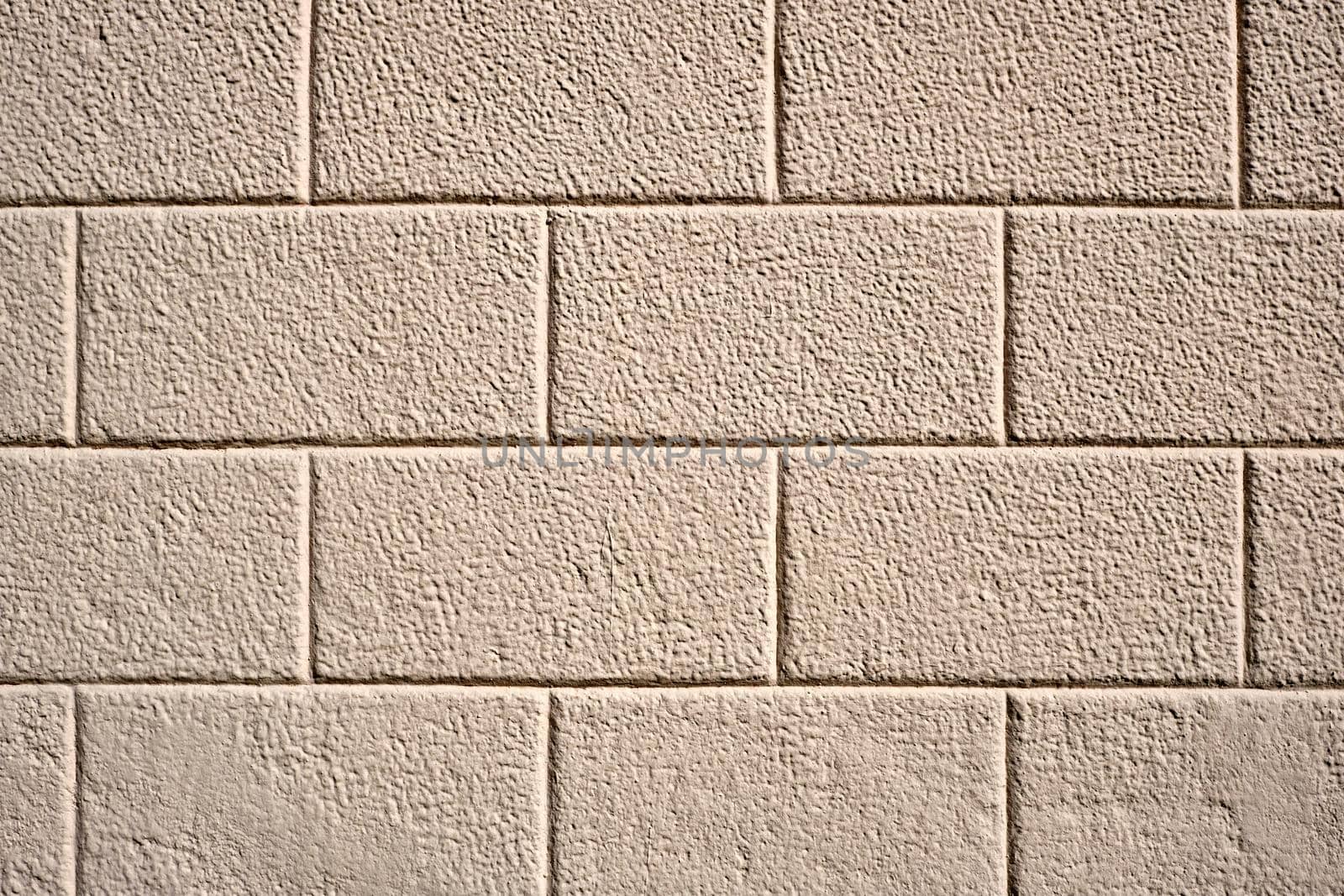 Wall with rectangular beige stone slabs by elxeneize