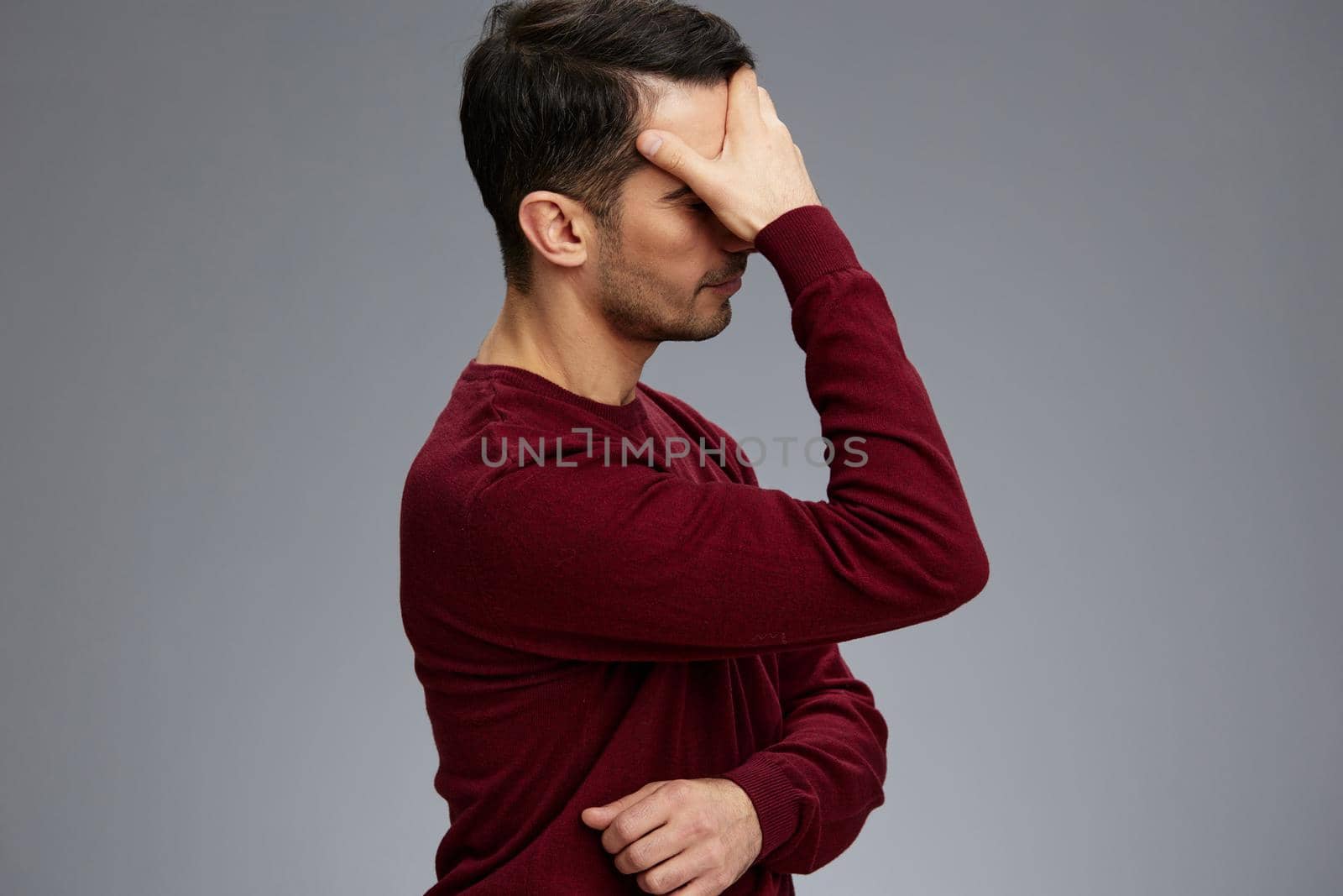 portrait man in a sweater posing emotions elegant style Gray background. High quality photo