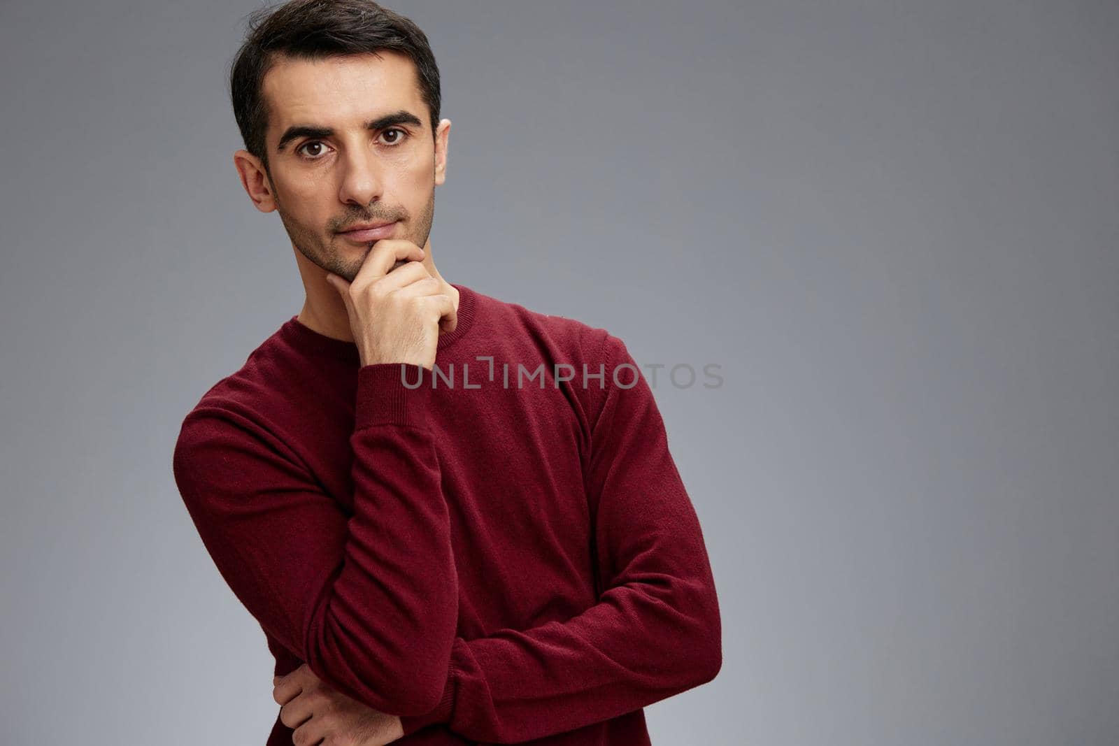successful man in a red sweater hand gesture posing self confidence cropped view. High quality photo