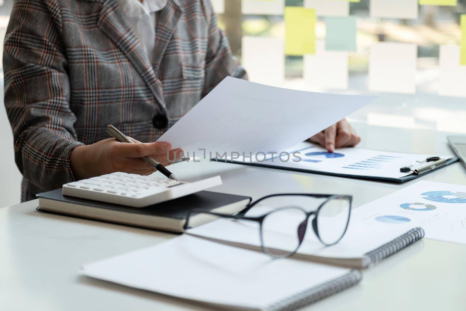 Accountant bookkeeper or financial inspector hands making report, calculating. Home finances, investment, economy, saving money or insurance concept.