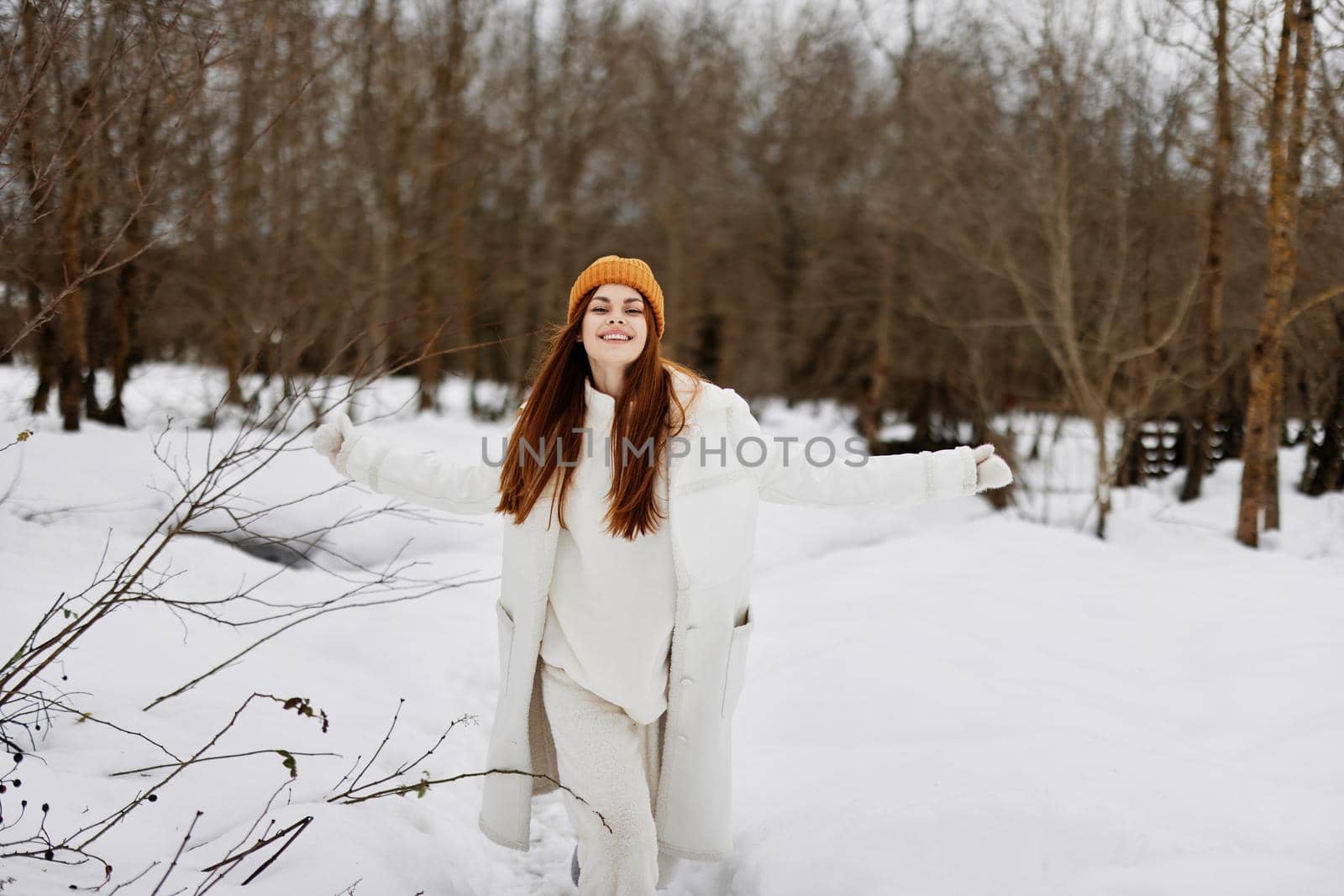 woman in winter clothes in a hat fun winter landscape There is a lot of snow around. High quality photo