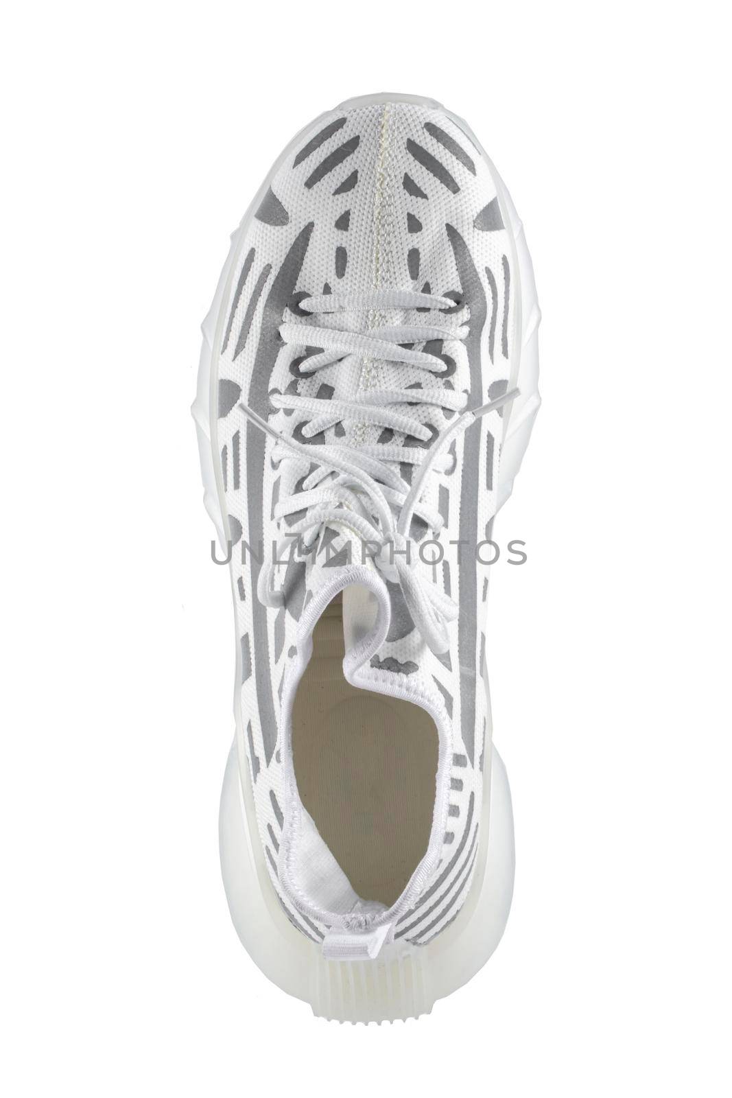 Sport shoes. White fabric trainers with gray reflective stripes.