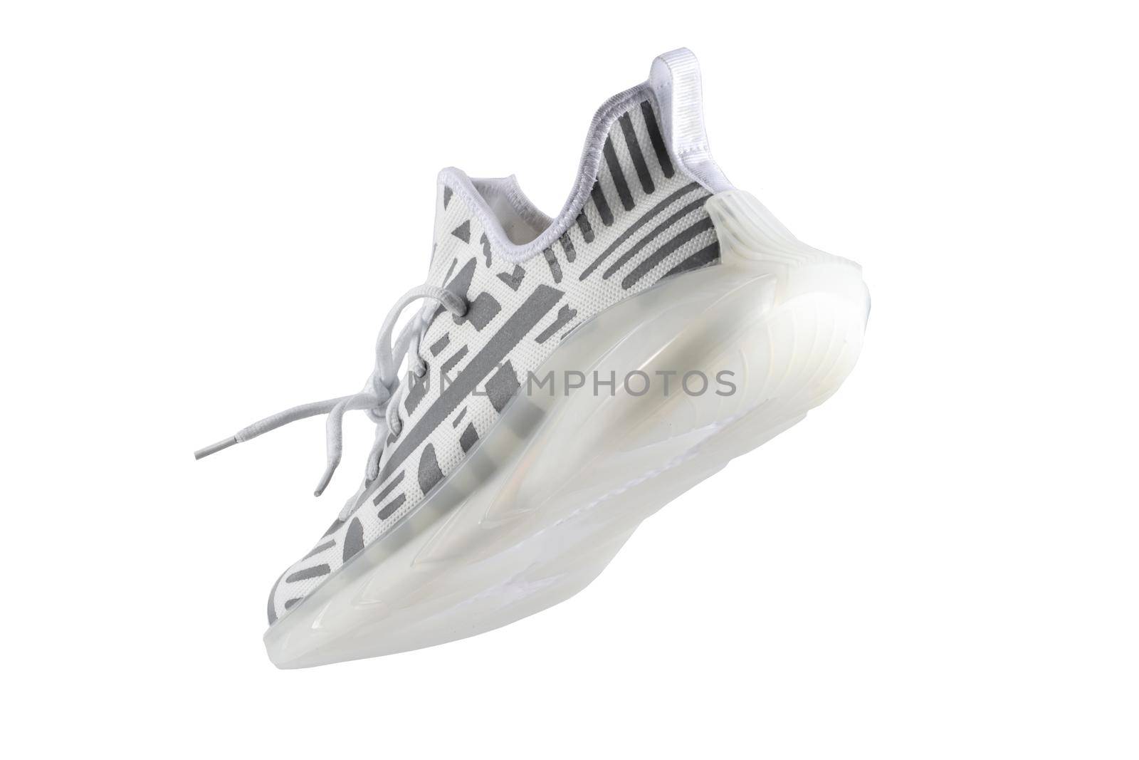 Sport shoes. White fabric trainers with gray reflective stripes.