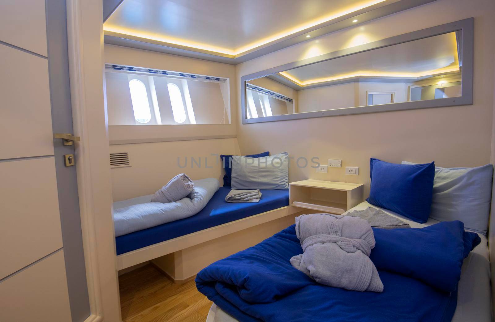 Interior decor of cabin bedroom on luxury sailing yacht with twin beds