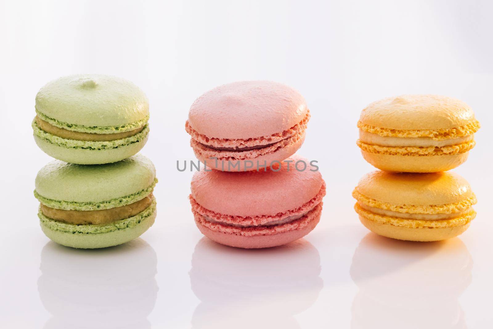 Sweet colorful macarons isolated on white background. Tasty colourful macaroons by uflypro