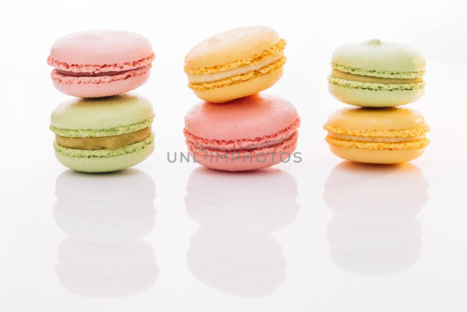 Colorful macarons dessert. French macarons on white background. Different colorful macaroon. Tasty sweet color macaron by uflypro