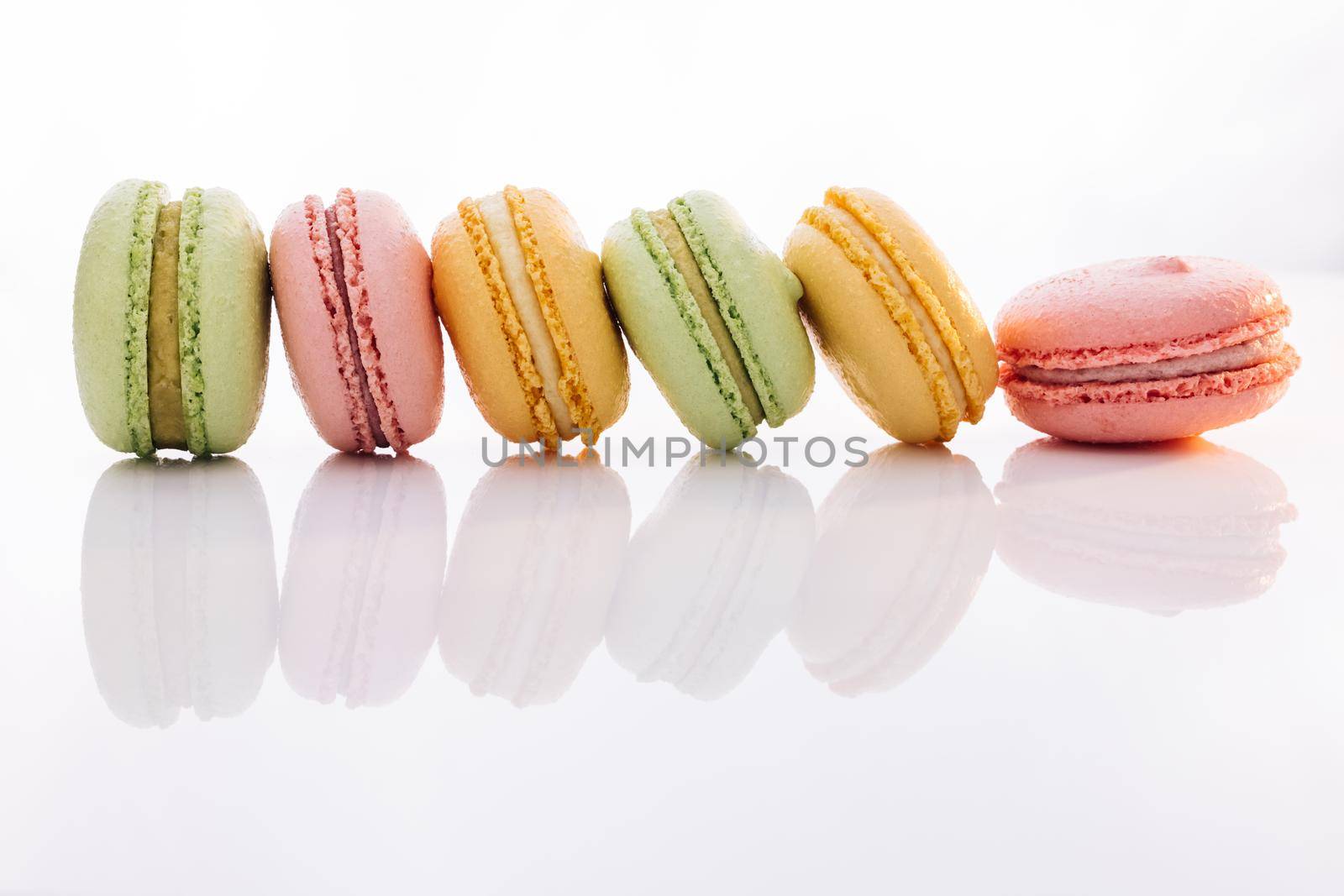 Colorful macarons dessert. French macarons on white background. Different colorful macaroon. Tasty sweet color macaron.