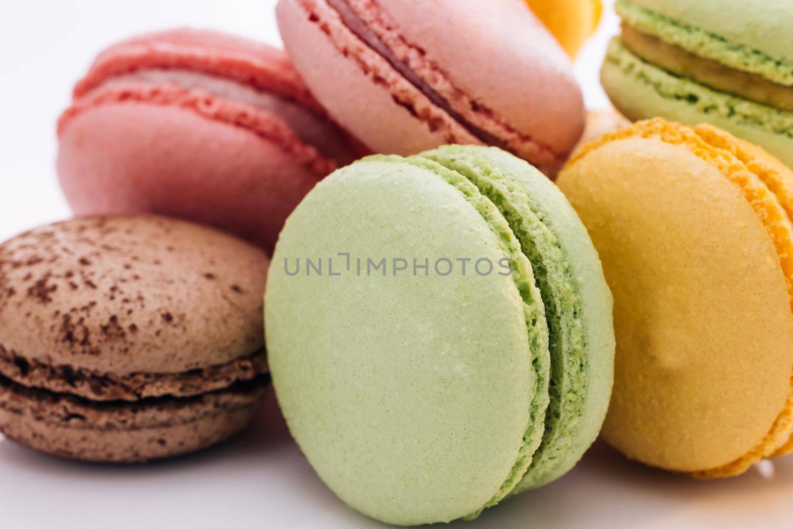 Multicolor macarons , French macaroon, greedy pastry. Close up of Multicolored Macarons Cookies. Food concept