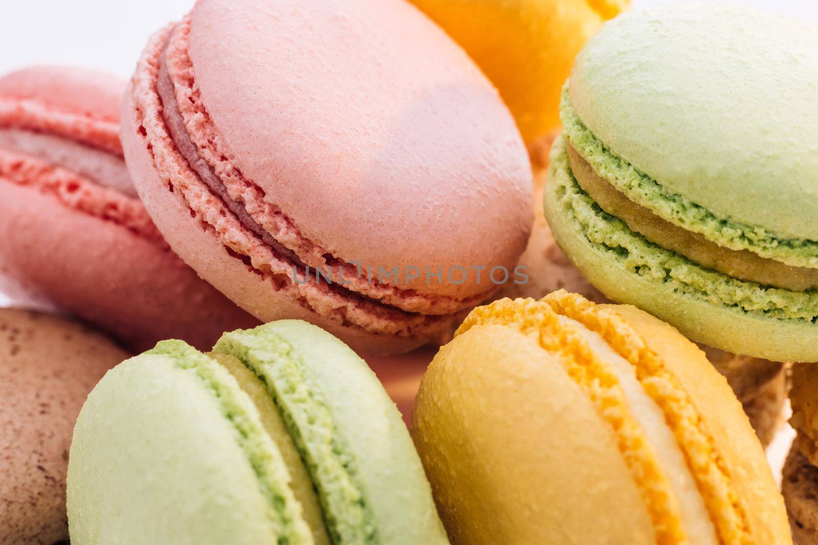 Close up of multicolor macarons French macaroon greedy pastry on white background. Macarons dessert. Food concept by uflypro