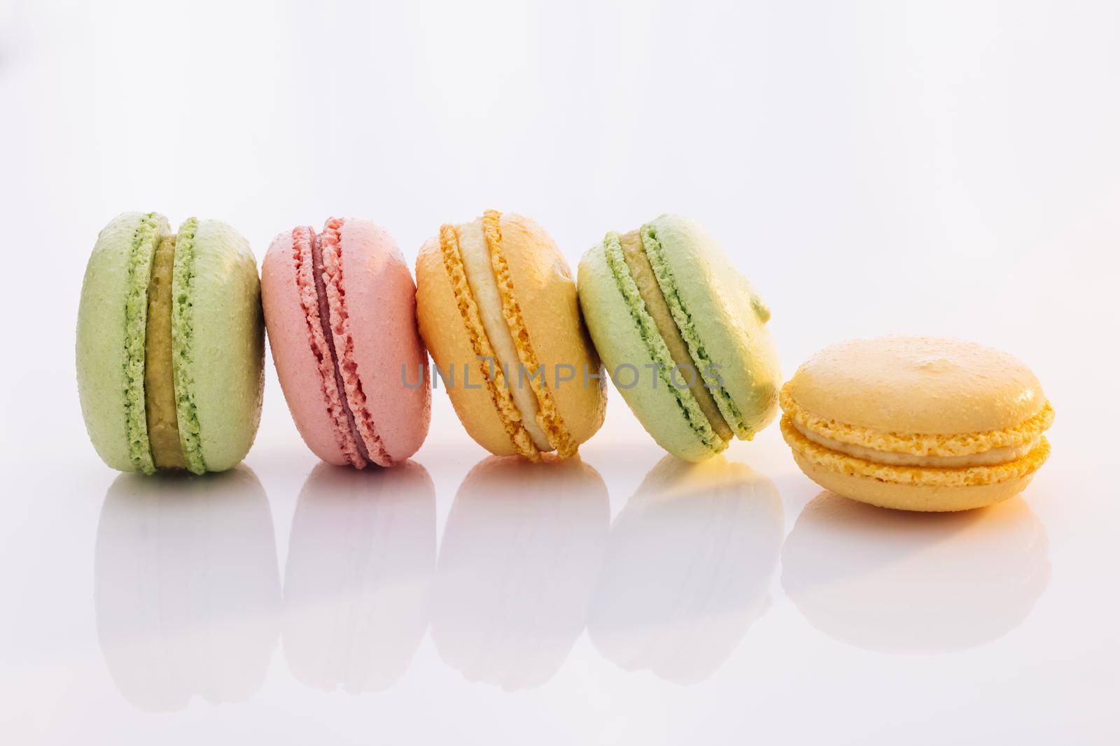 French macarons on white background. Different colorful macaroon. Tasty sweet color macaron. Colorful macarons dessert by uflypro