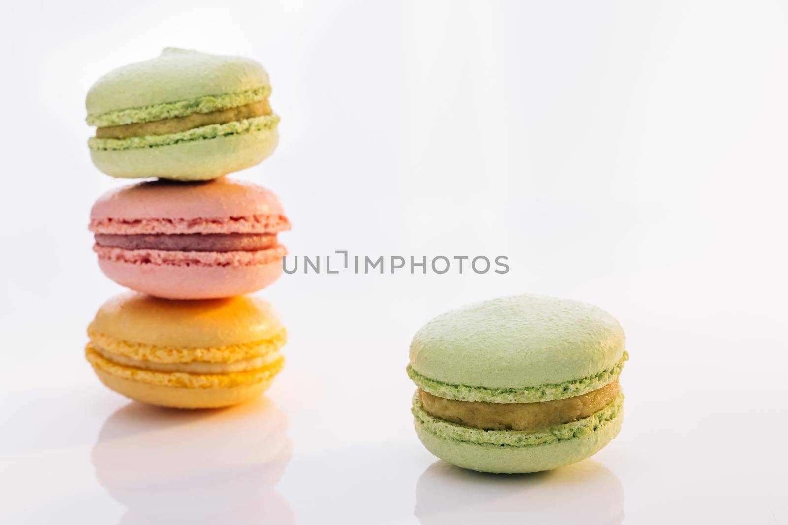 Sweet colorful macarons isolated on white background. Tasty colourful macaroons. Macarons against a bright white background by uflypro