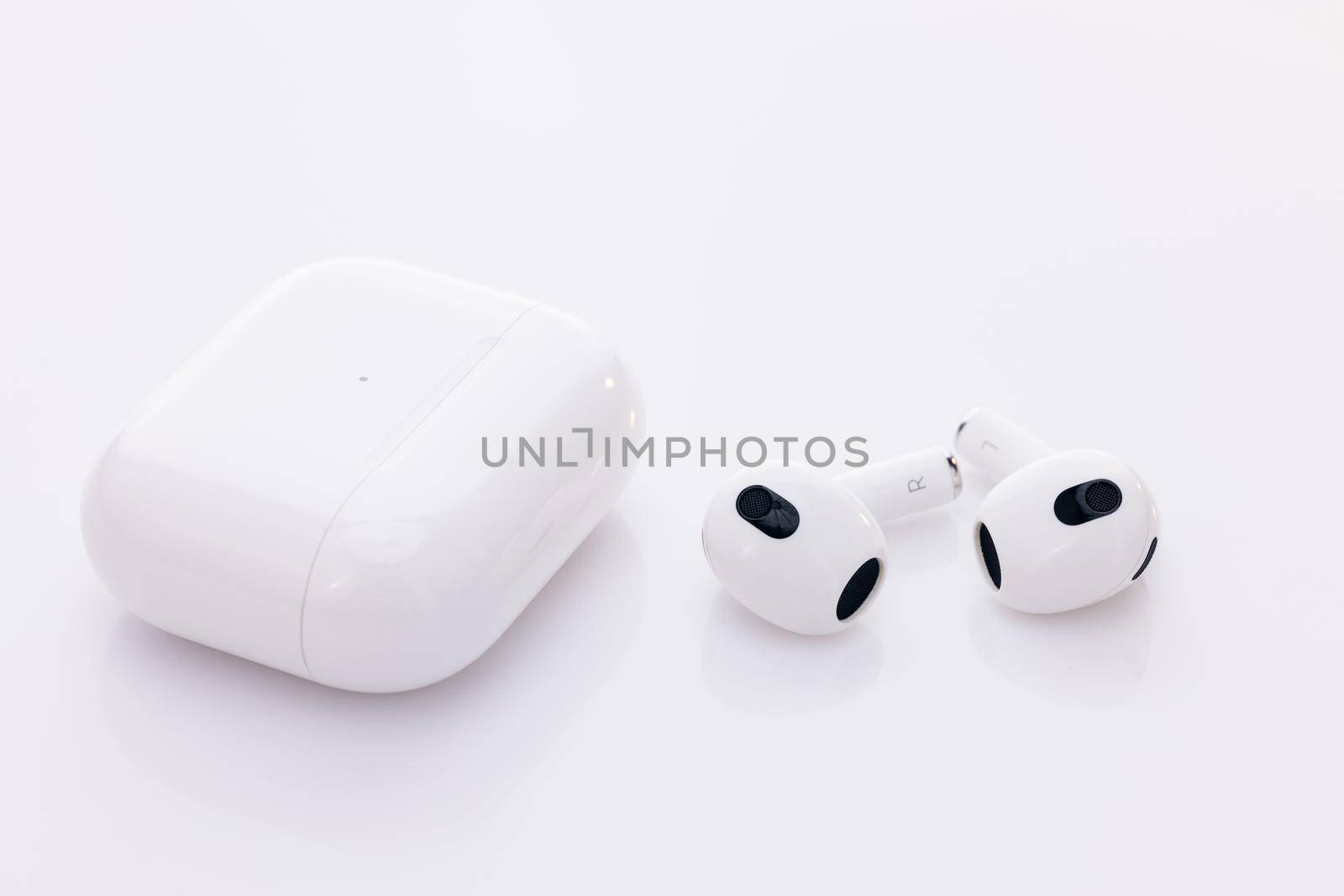 Wireless earphone with noise cancelling technology. Bluetooth headphones isolated on white background. Gadgets and electronic devices. Wireless headphones with charging case. by uflypro