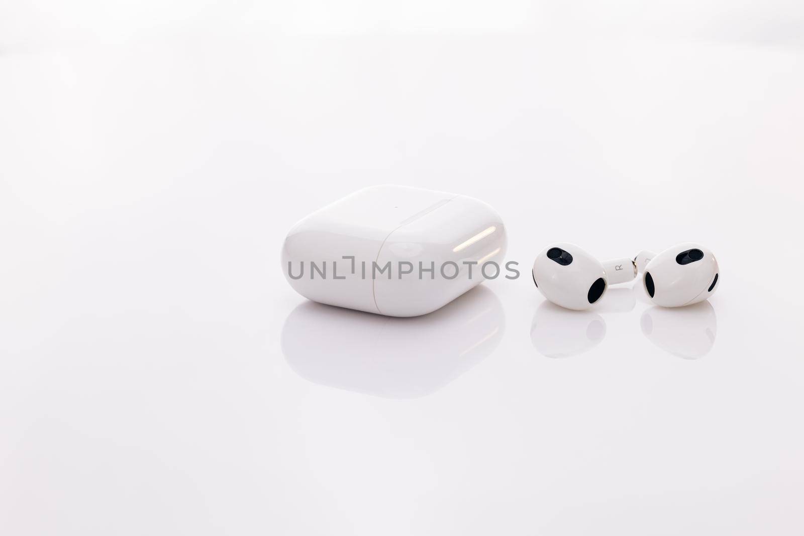 Wireless headphones with charging case. Wireless earphone with noise cancelling technology. Gadgets and electronic devices. Bluetooth headphones isolated on white background