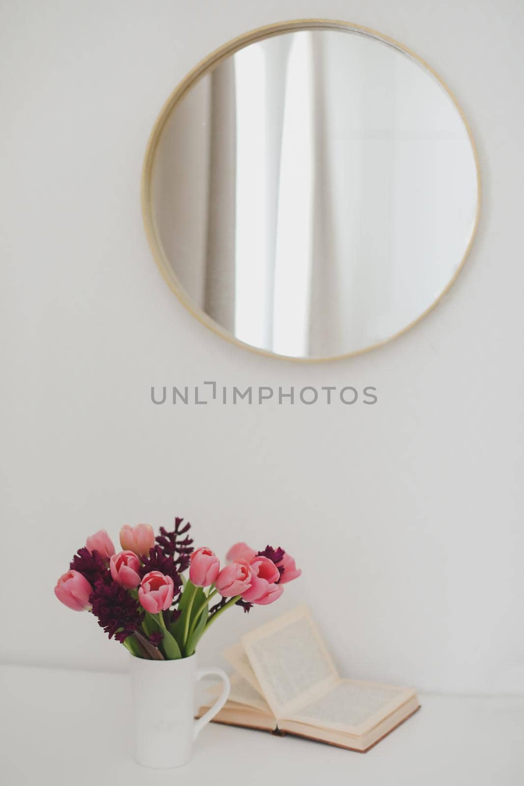 cozy spring home decor with a pink tulip bouquet in daylight. Spring stll life, birthday, Easter concept.
