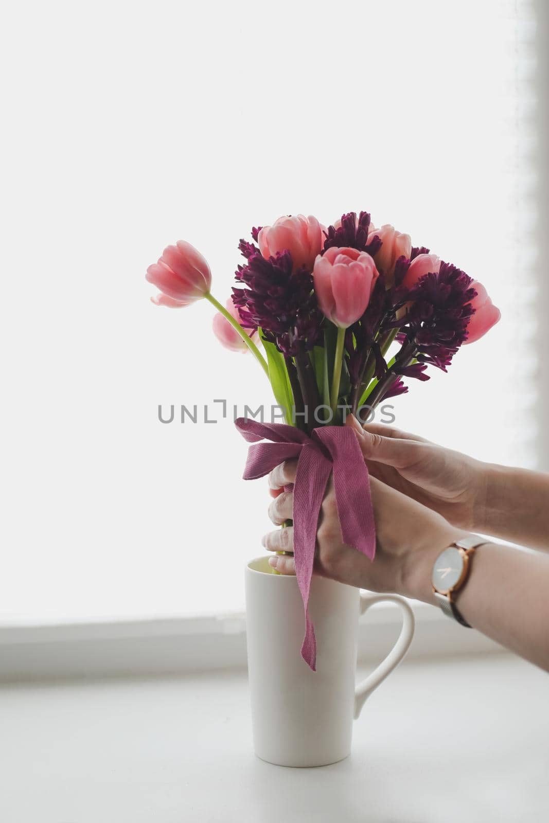cozy spring home decor with a pink tulip bouquet in daylight. Spring stll life, birthday, Easter concept.