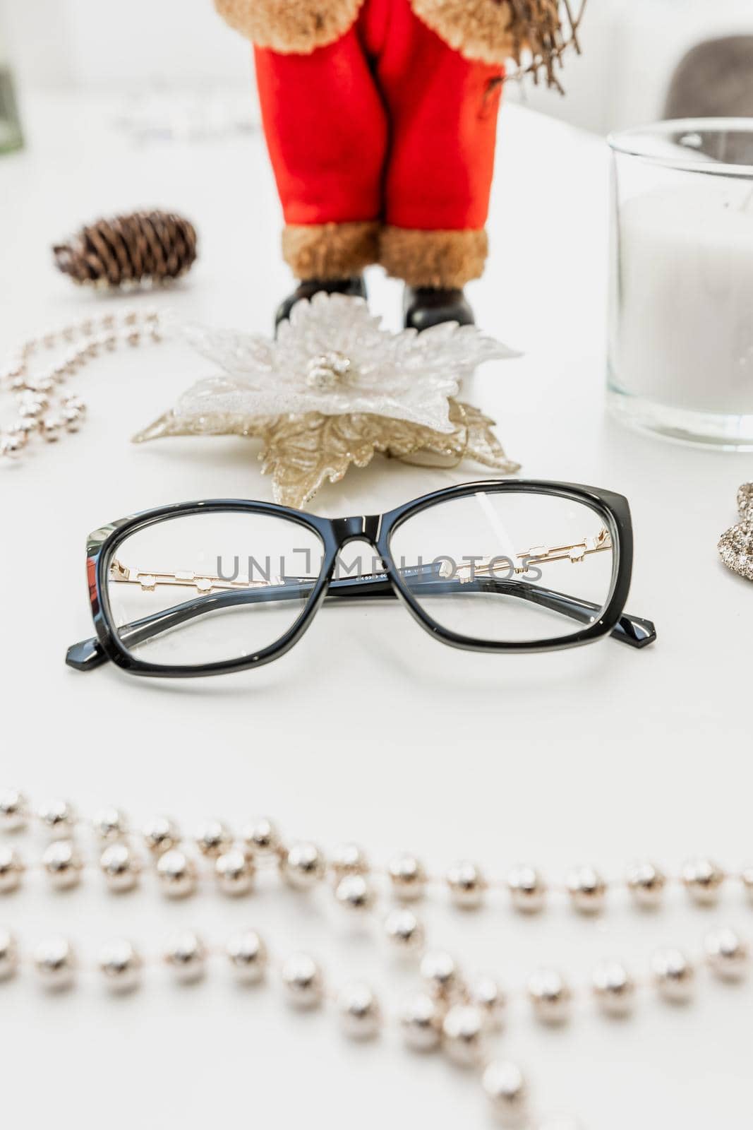 Glasses on a white table surrounded by beads by wip3out