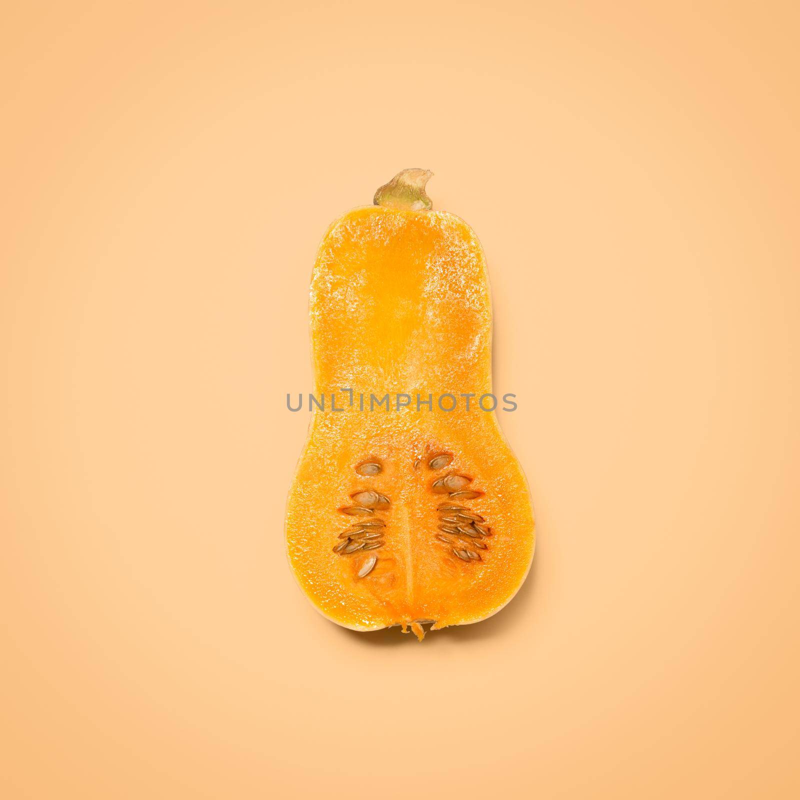 Perfect by itself or in a salad. Shot of a butternut squash against a studio background. by YuriArcurs