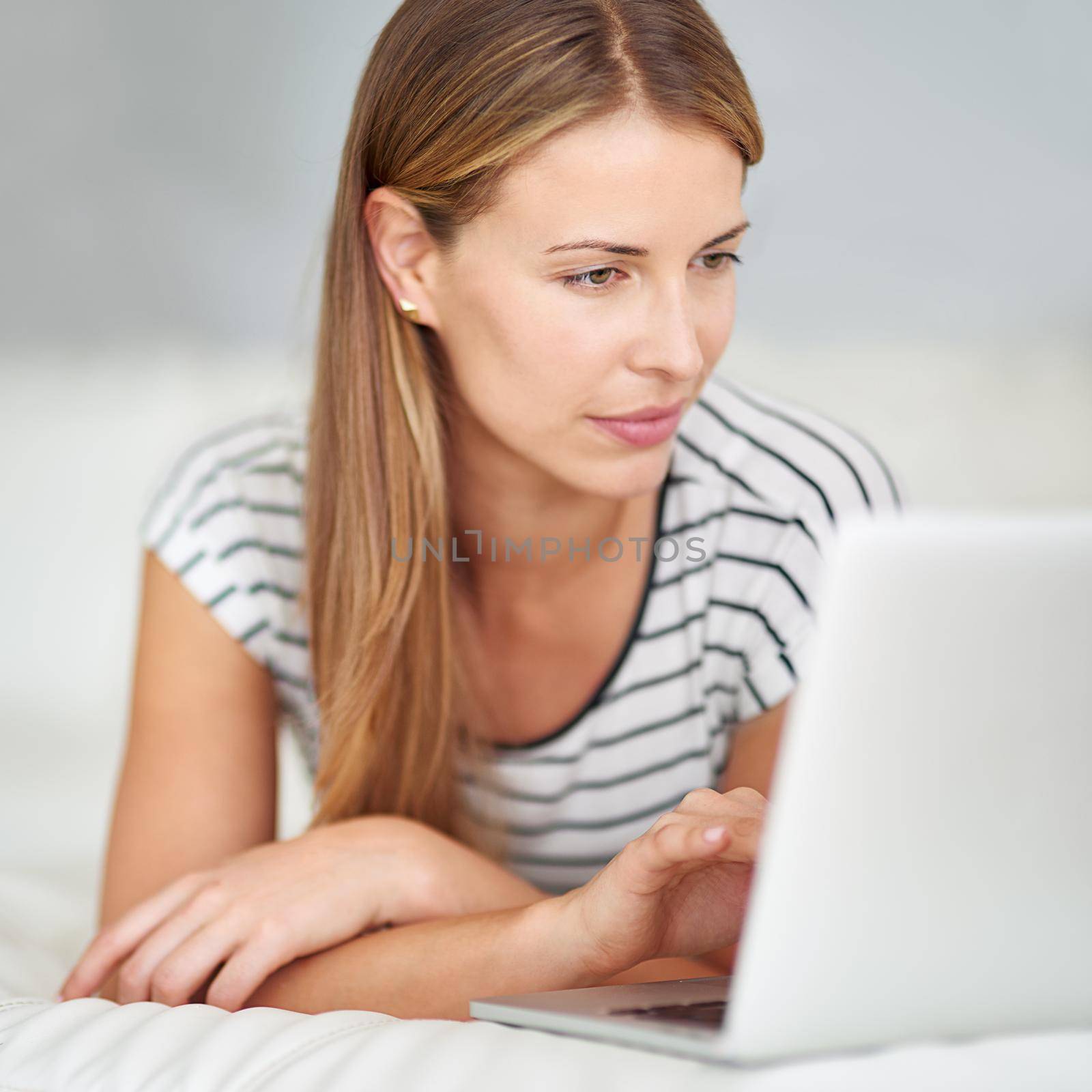 Shot of a young woman browsing the internet at home.