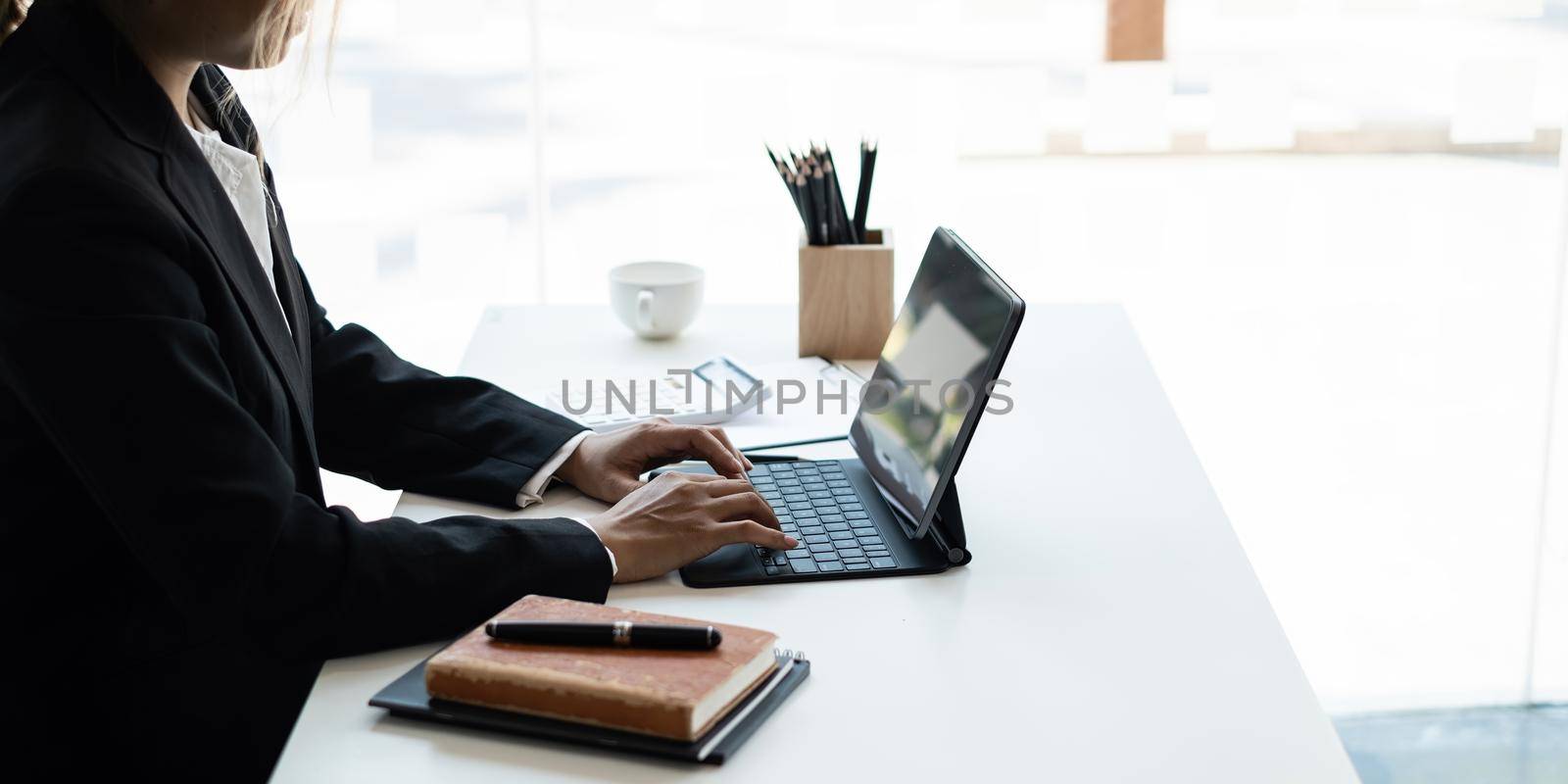 Business woman using digital tablet at office, account or saving money or insurance concept