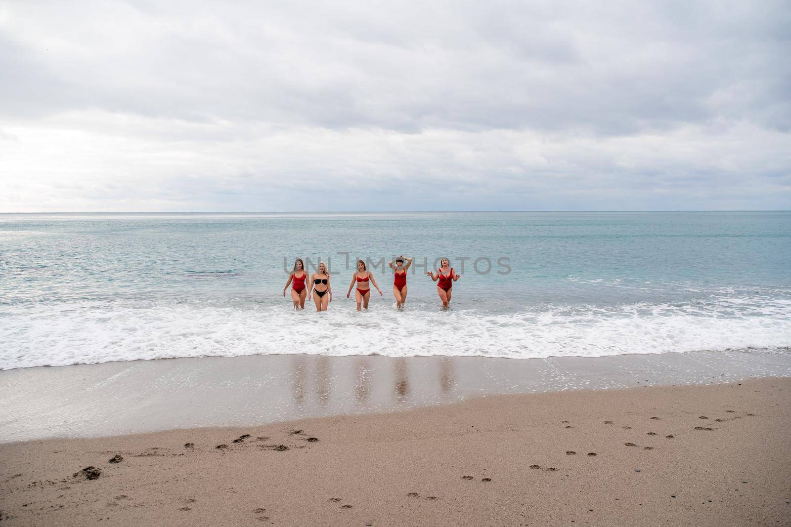 Big happy family or group of five friends is having fun against sunset beach. Beach holidays concept. by Matiunina