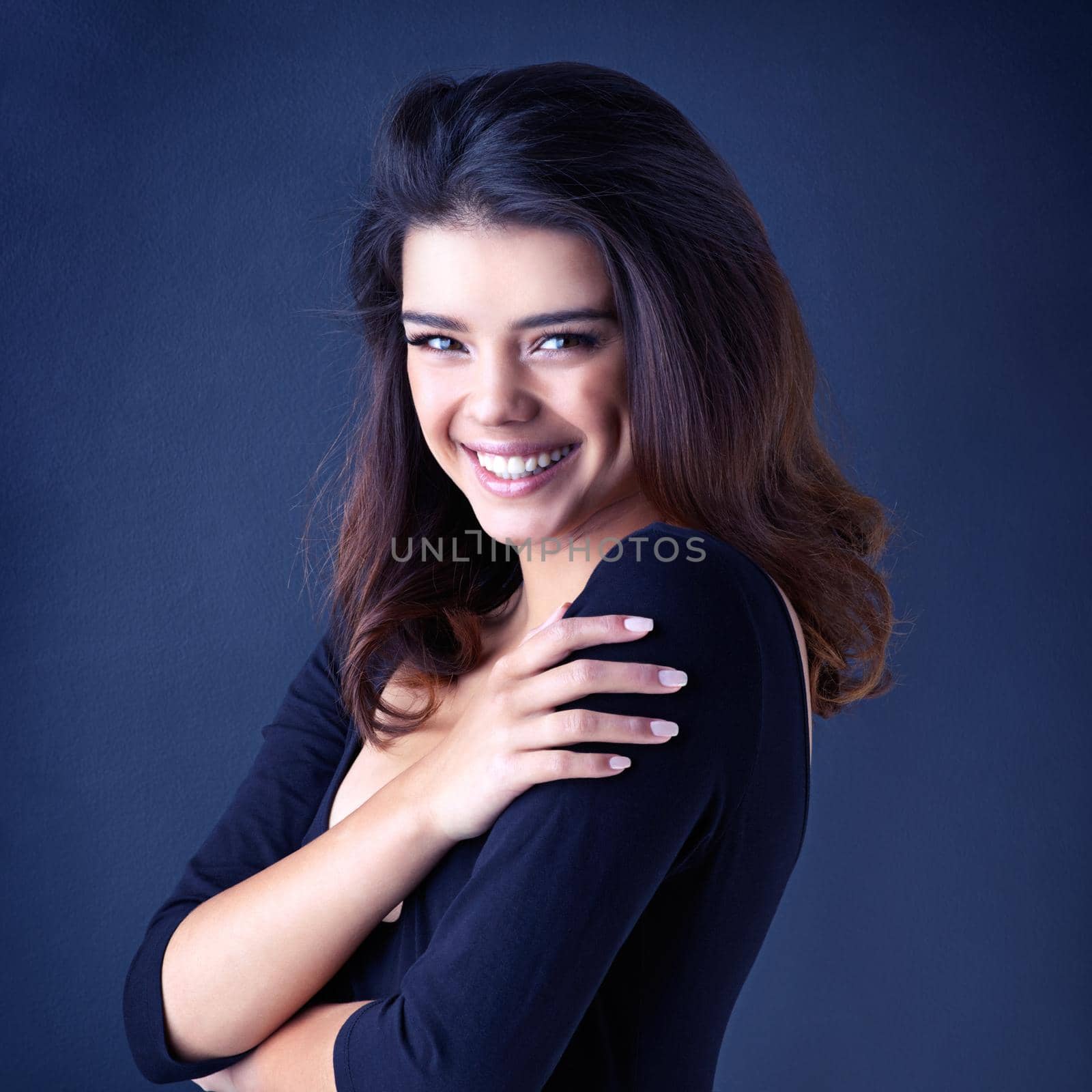 Have a great hair day. Studio shot of a beautiful young woman posing in the studio. by YuriArcurs