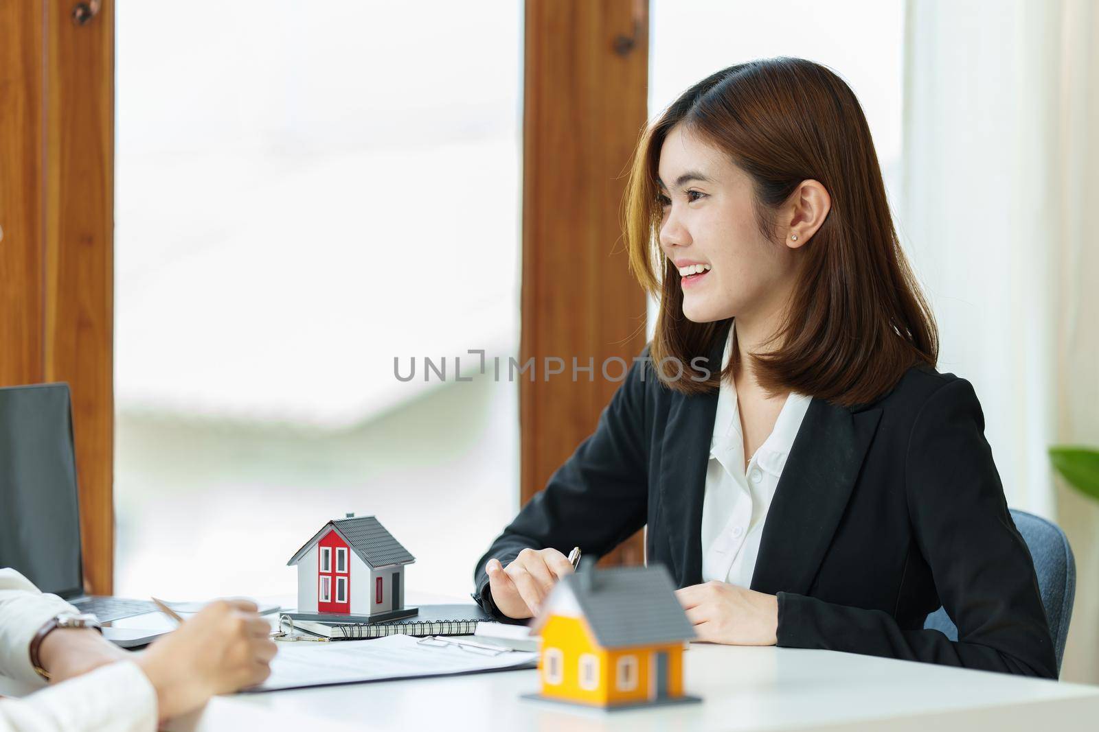 Agent explain house insurance contract to customer at office. Real Estate concept