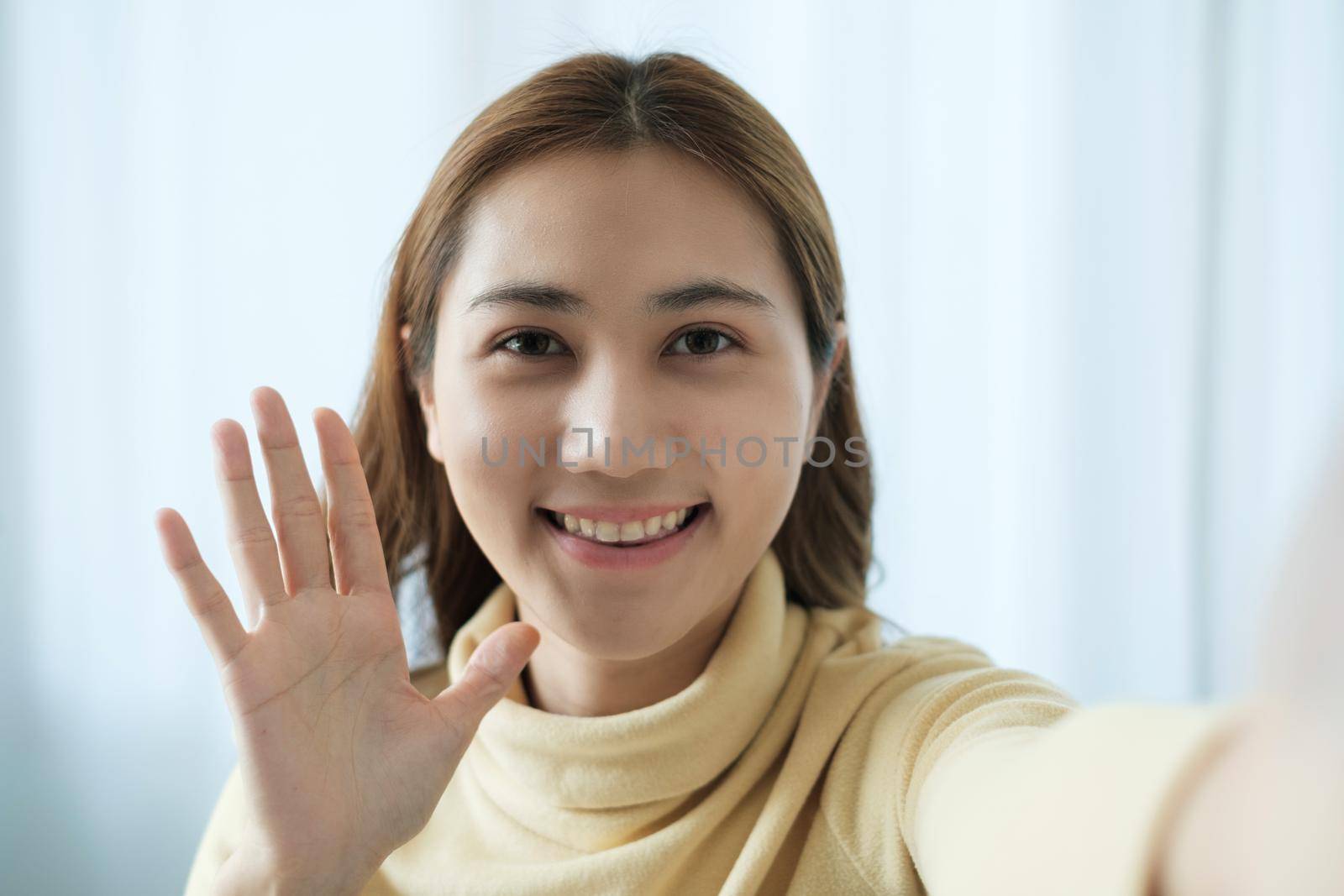 Young Asian Woman using video chat by smartphone to talking with her friend. by itchaznong