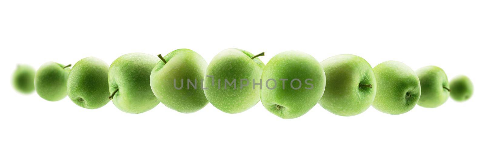 Green apples levitate on a white background.