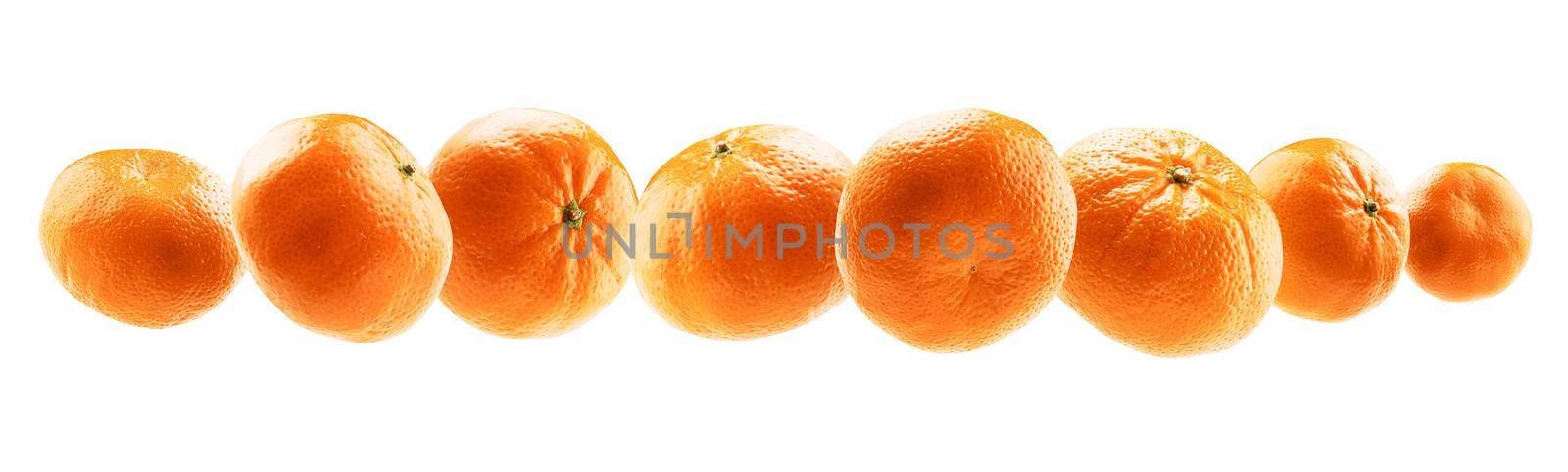 Orange tangerines levitate on a white background.