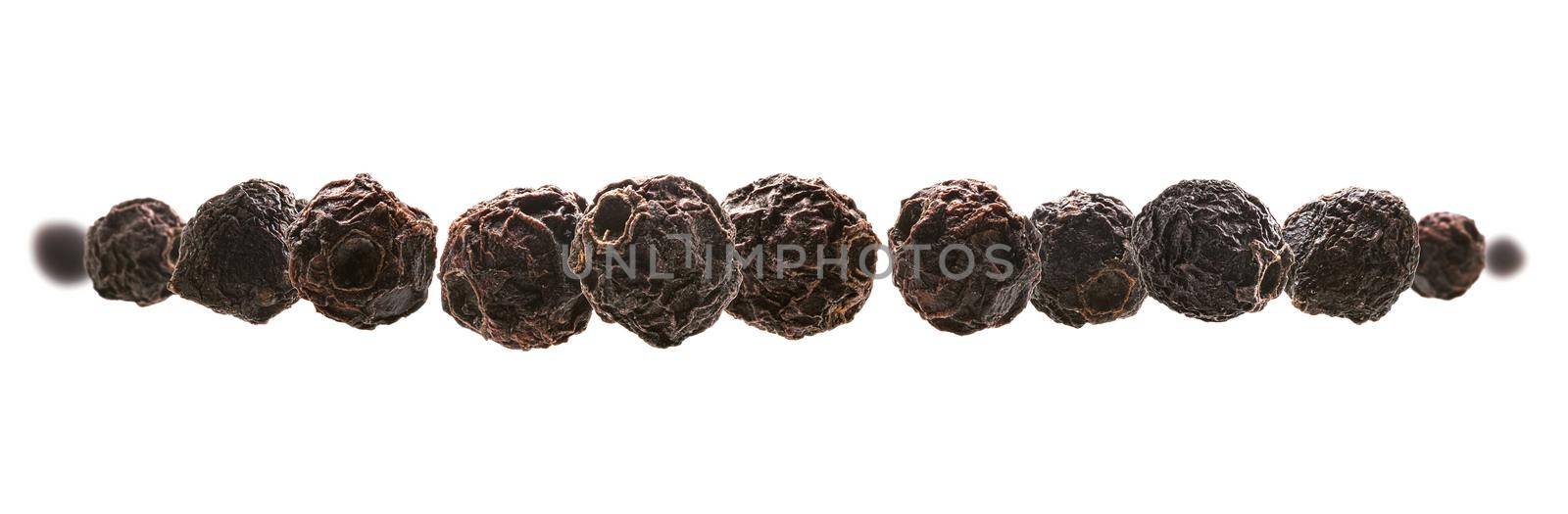 Dried hawthorn berries levitate on a white background.