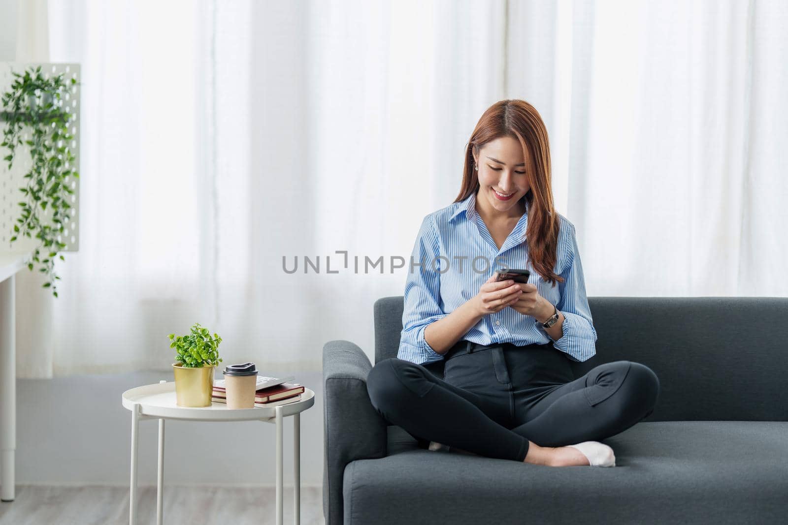 Woman using shopping application by cell phone and payment by credit card