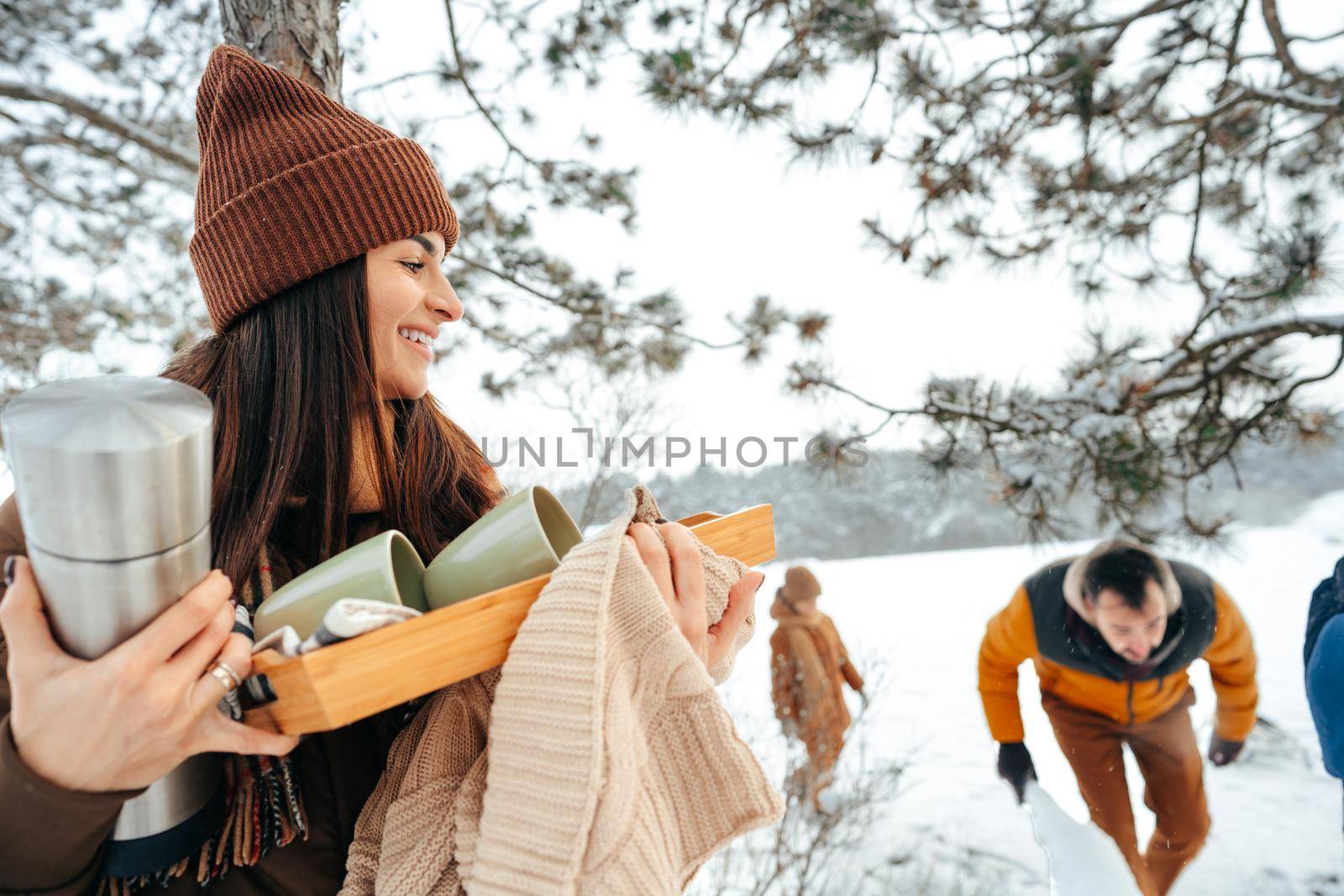 Young woman taking luggage out of car on winter trip, close up