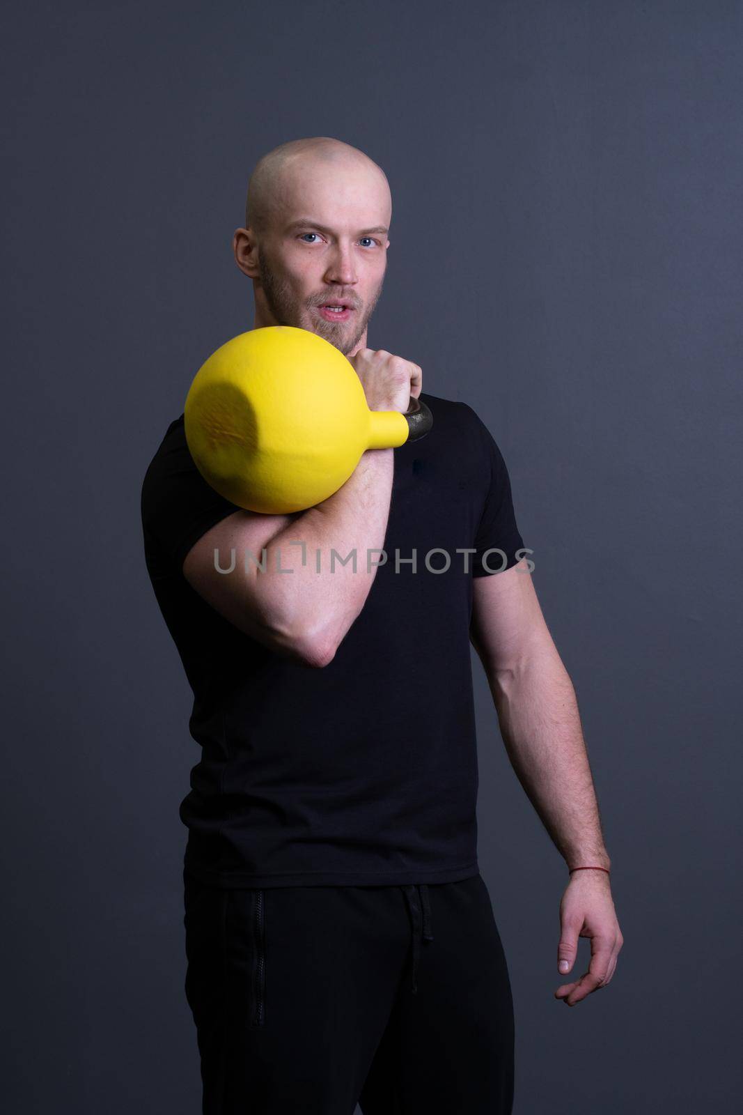 Guy with a yellow kettlebell gym anonymous yellow strength, from motivation teenager for strong and resitance sportswear, vietnamese filipino. Healthy bent health, club hiit