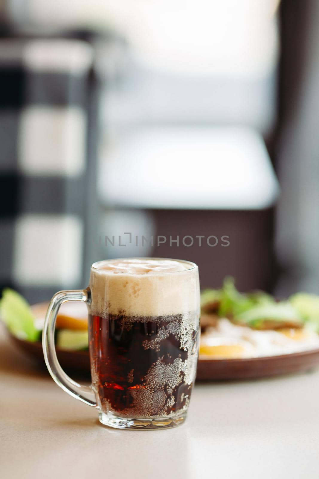 Beer cup standing near appetizers plate. Looking mouthwatering. Cold and fresh. For friends company. by StudioLucky