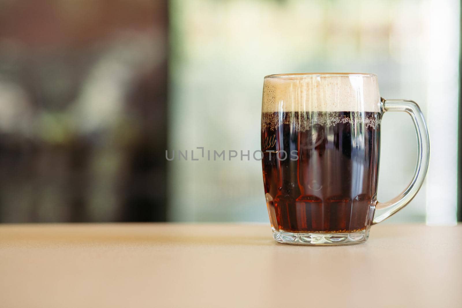 Horizontal photo of glass cup full of beer. by StudioLucky