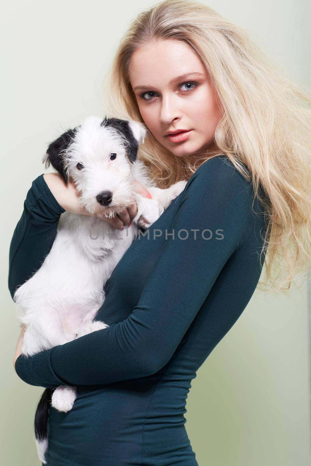 Posing with her favourite friend. Portrait of a gorgeous young woman holding her adorable dog. by YuriArcurs