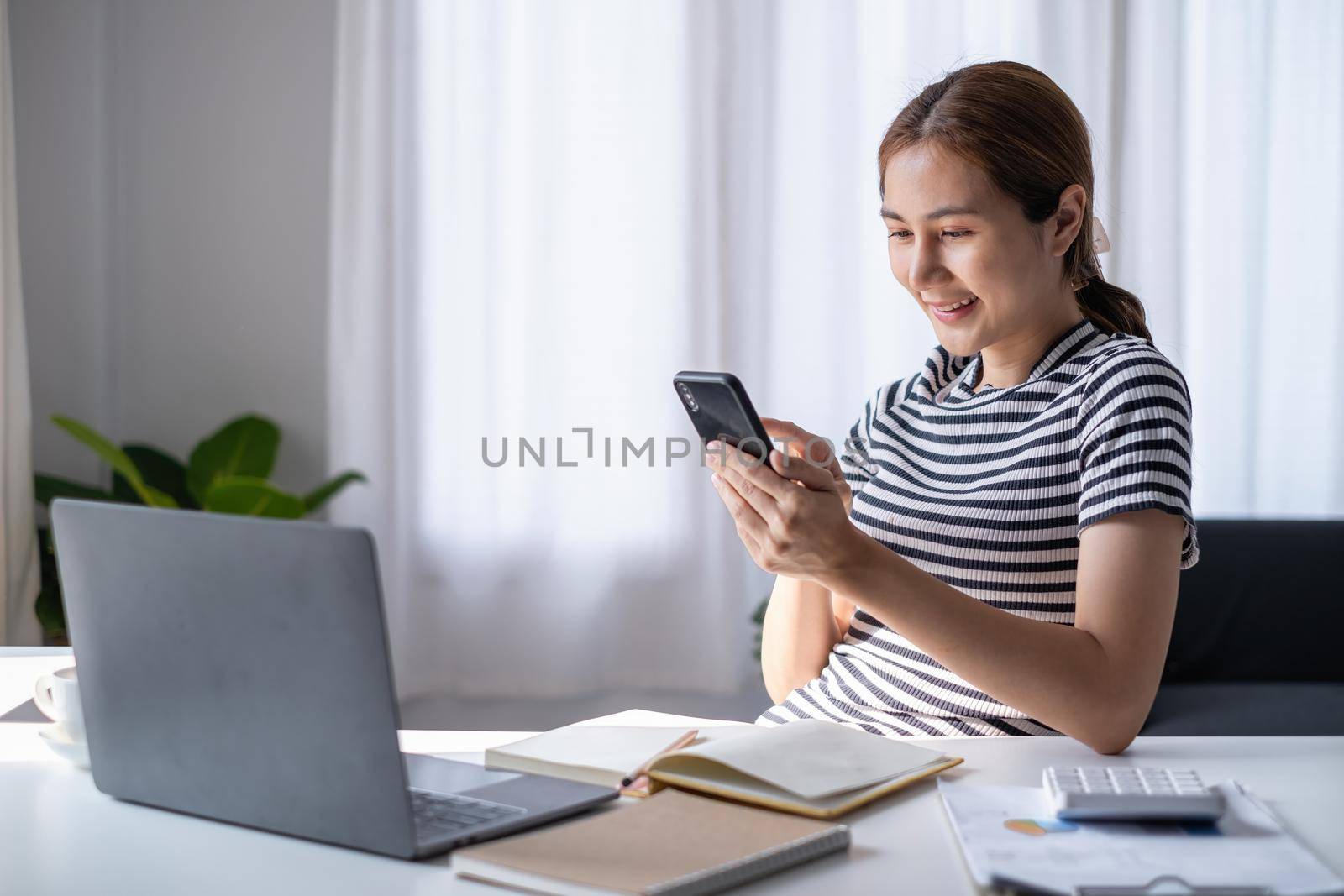 Young Asian Woman using video chat by smartphone to talking with her friend. by itchaznong