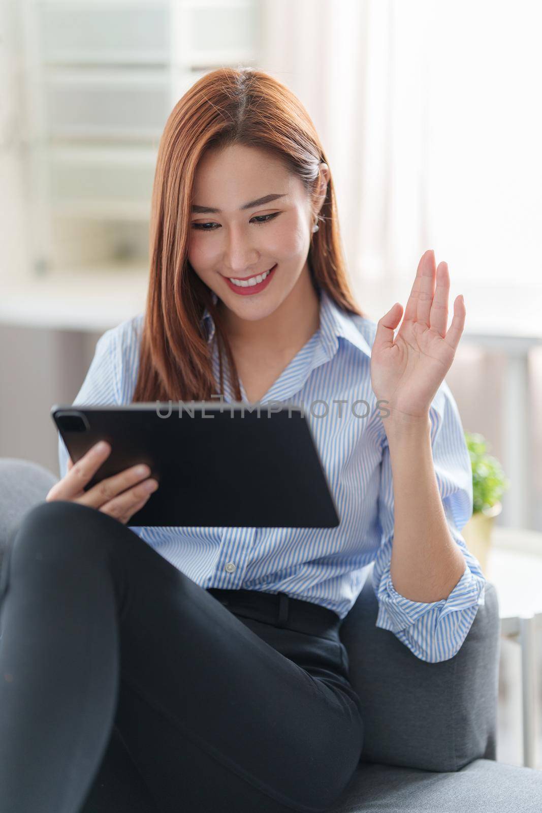 Beautiful asian woman using video call application. blogger, video conference, comfortable usage concept. by itchaznong