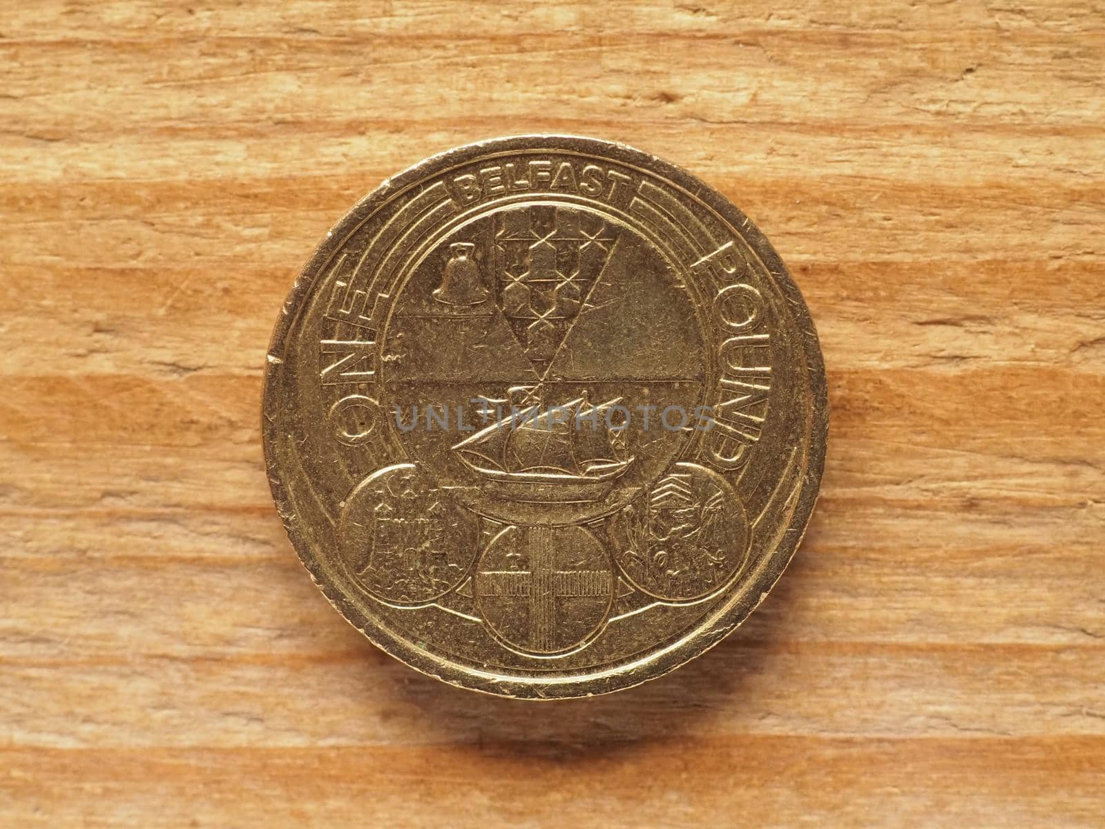 one pound coin reverse side showing badge of Belfast, currency of the United Kingdom