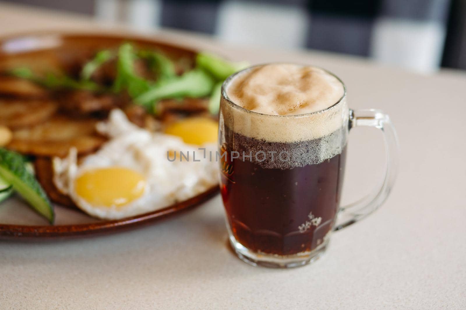 Beer cup standing near appetizers plate. Looking mouthwatering. Cold and fresh. For friends company. by StudioLucky