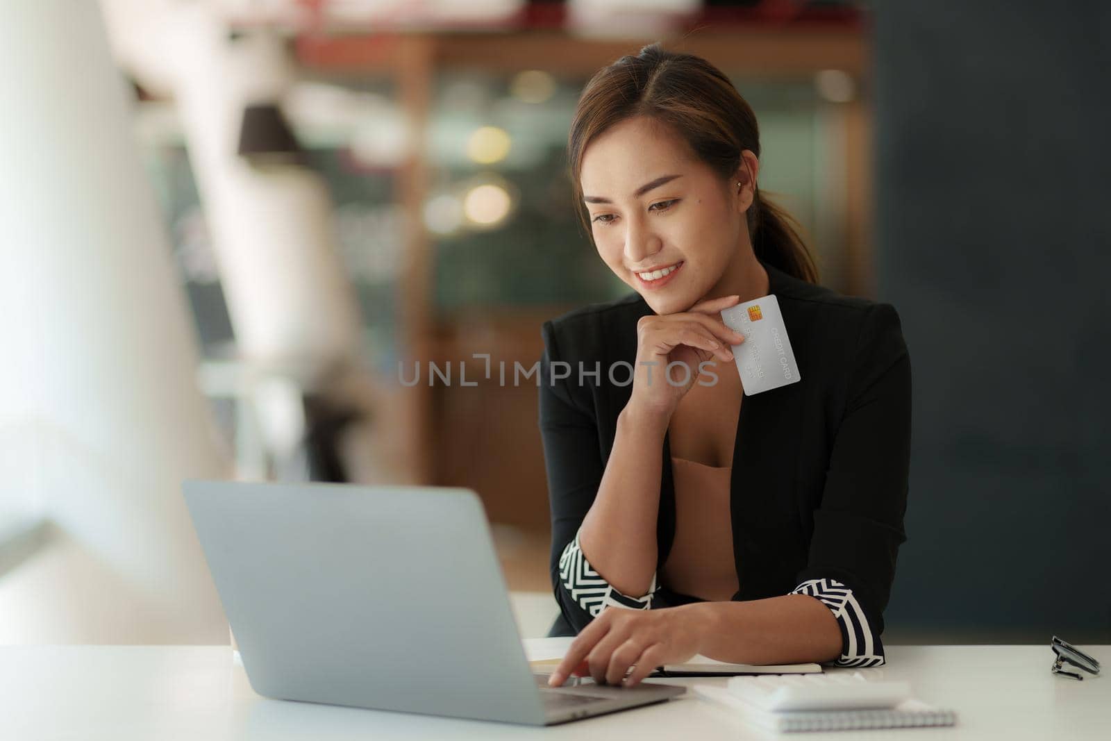 Woman using shopping web site by laptop computer and payment by credit card