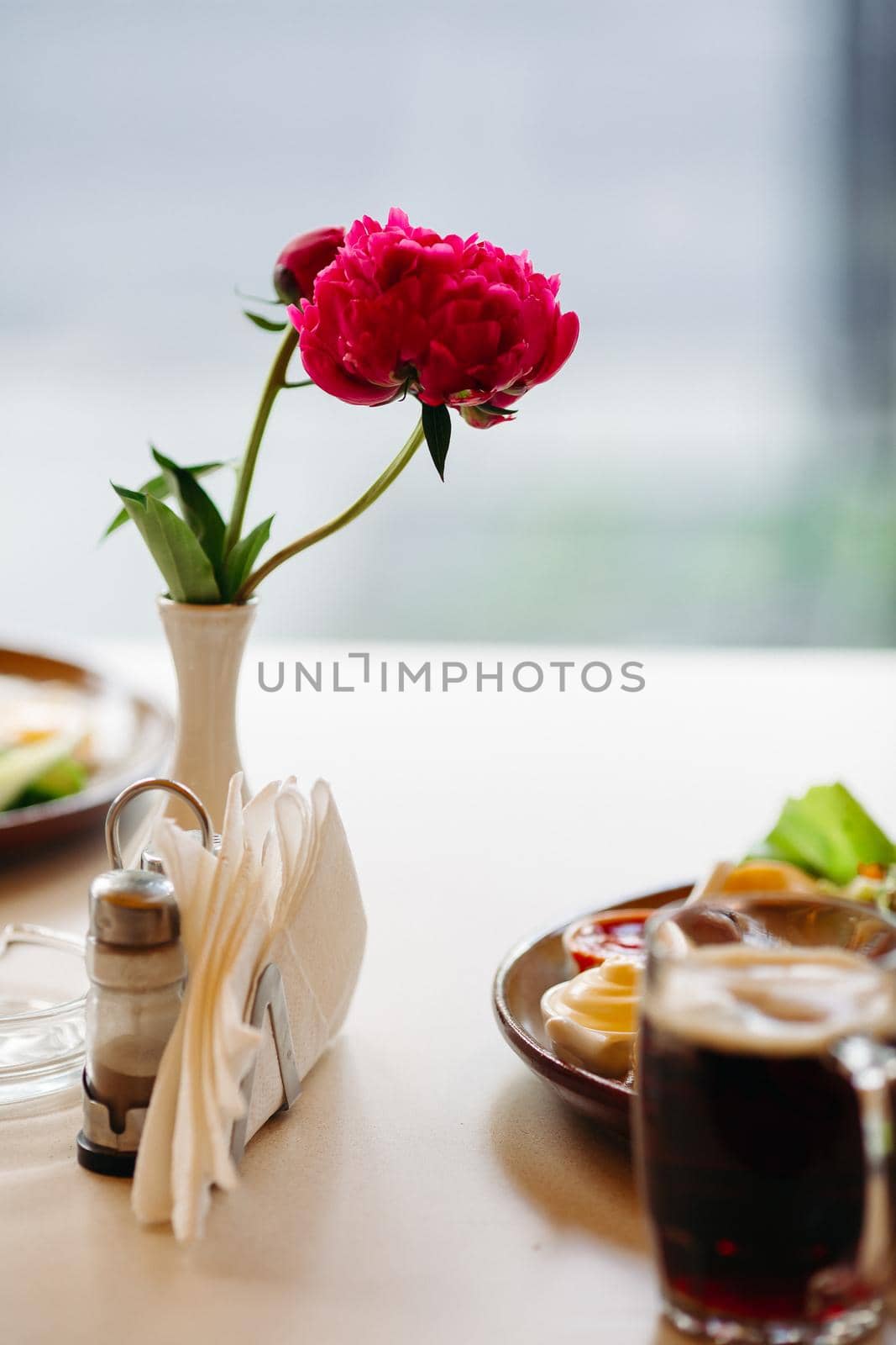 Beer cup standing near appetizers plate. Looking mouthwatering. Cold and fresh. For friends company. by StudioLucky