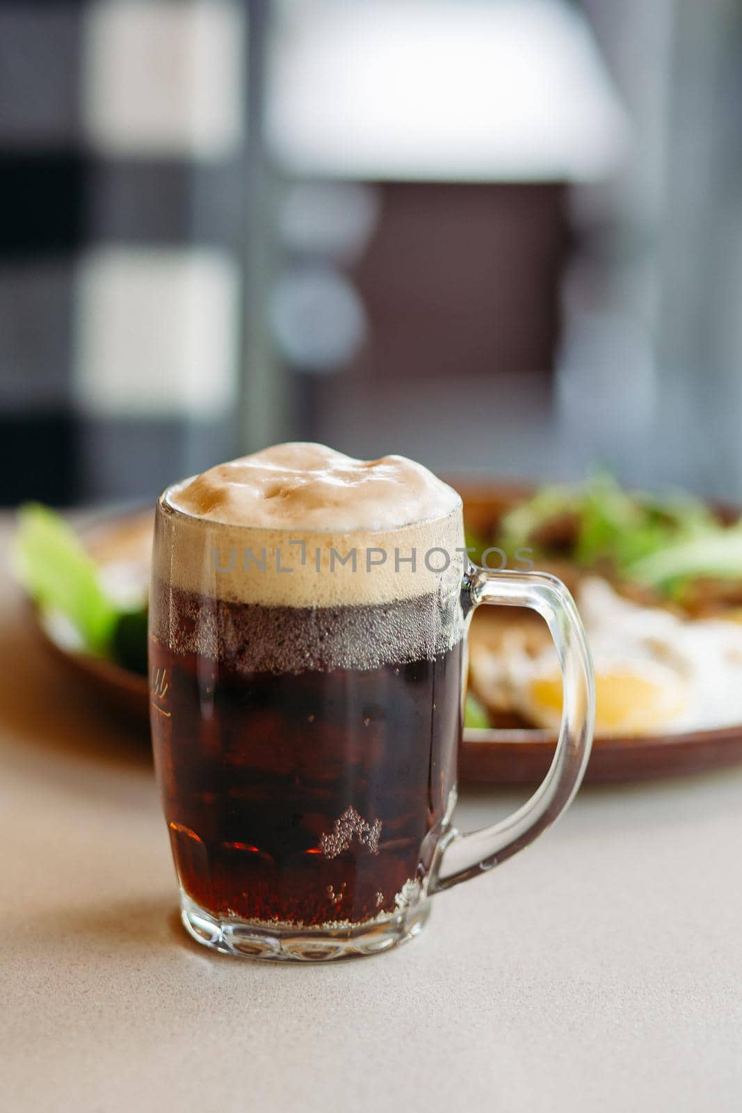 Beer cup standing near appetizers plate. Looking mouthwatering. Cold and fresh. For friends company. by StudioLucky