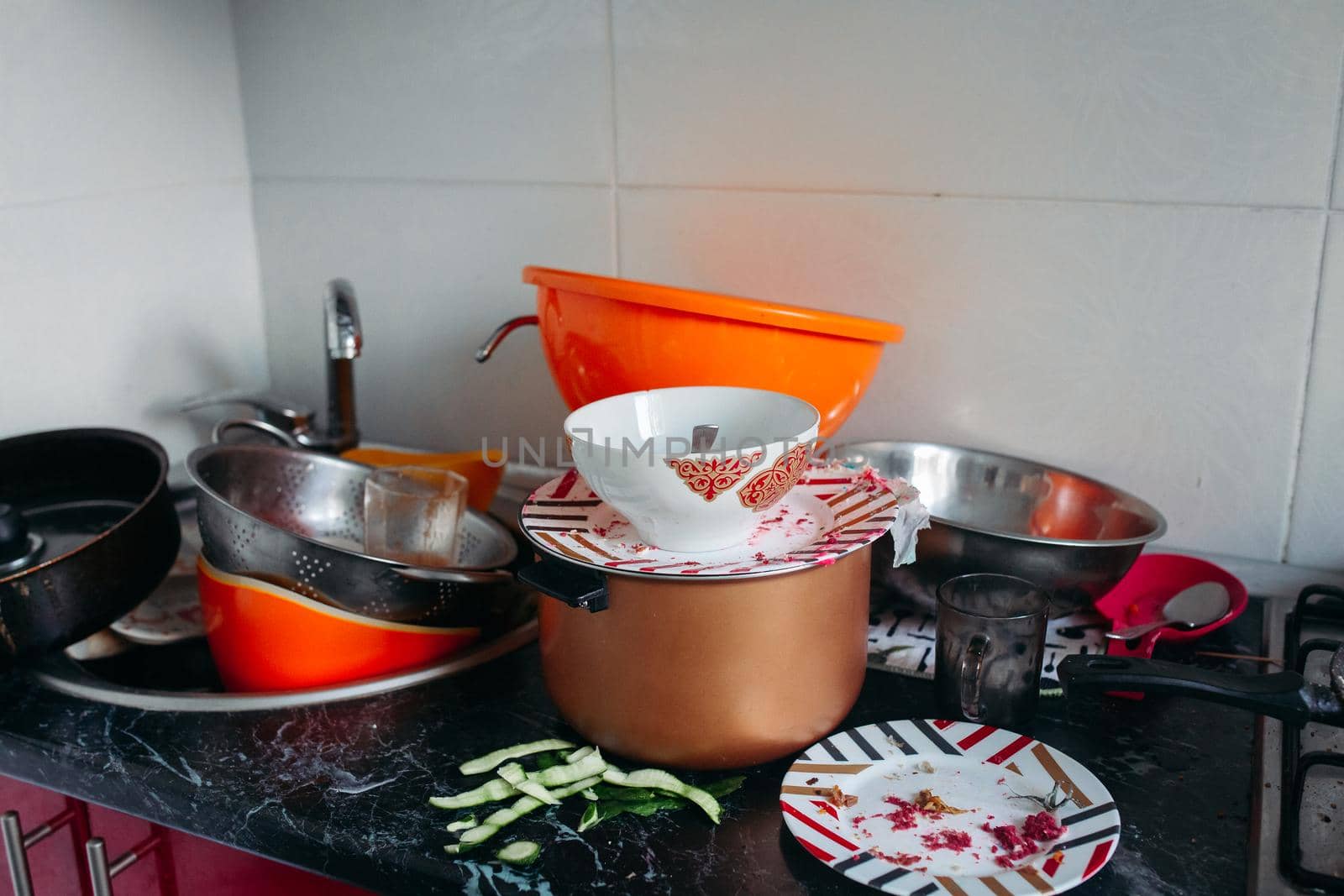 huge heap of dirty dishes waiting for the washing. Dirty dishes after the party at home. Food leftovers