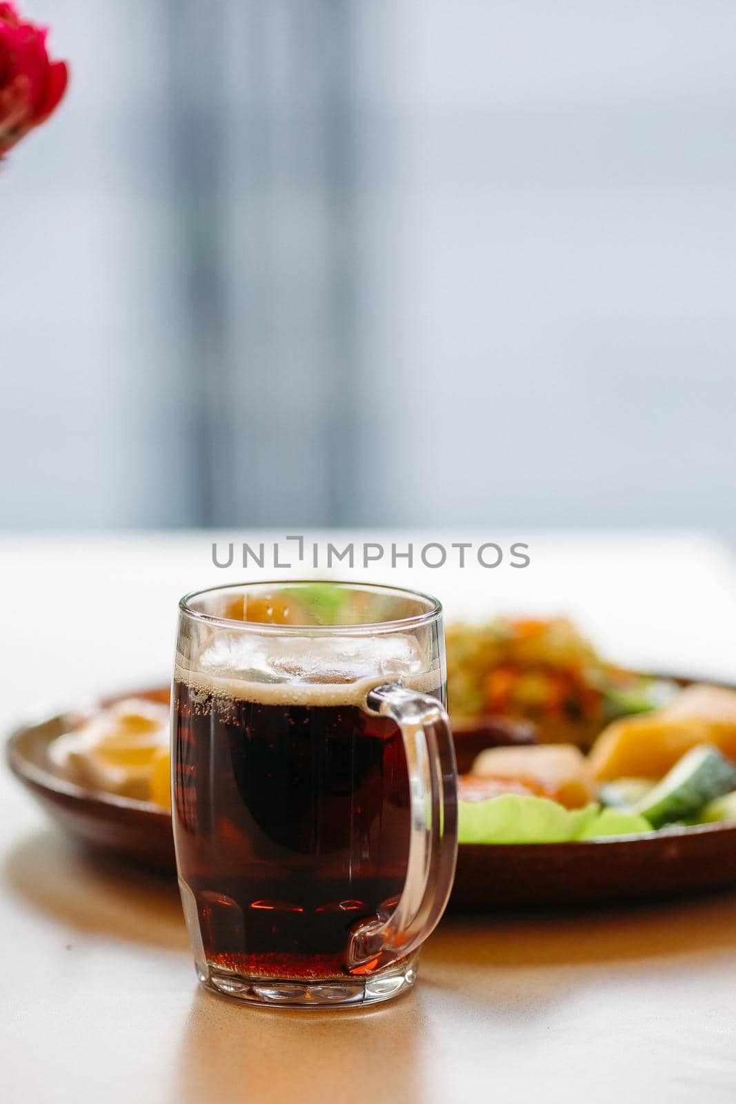 Beer cup standing near appetizers plate. Looking mouthwatering. Cold and fresh. For friends company. by StudioLucky